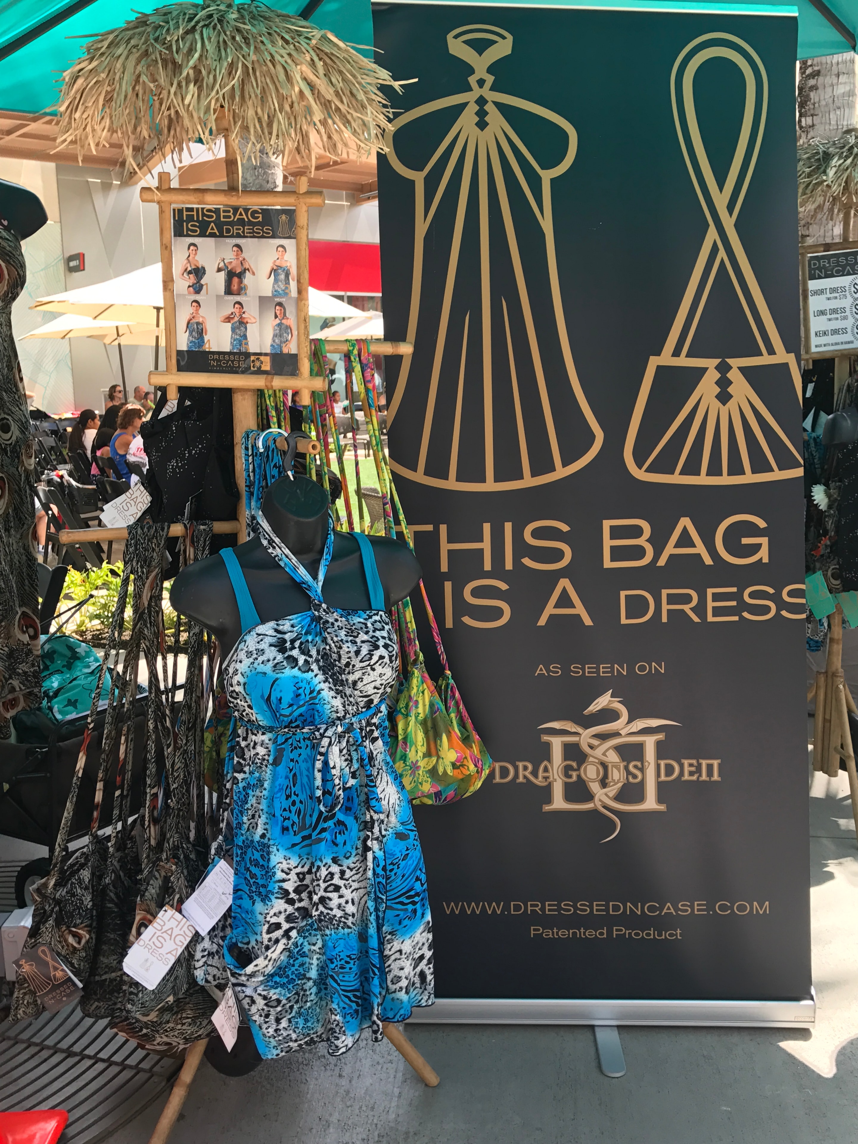 Fashion retail booth displaying convertible bag dresses