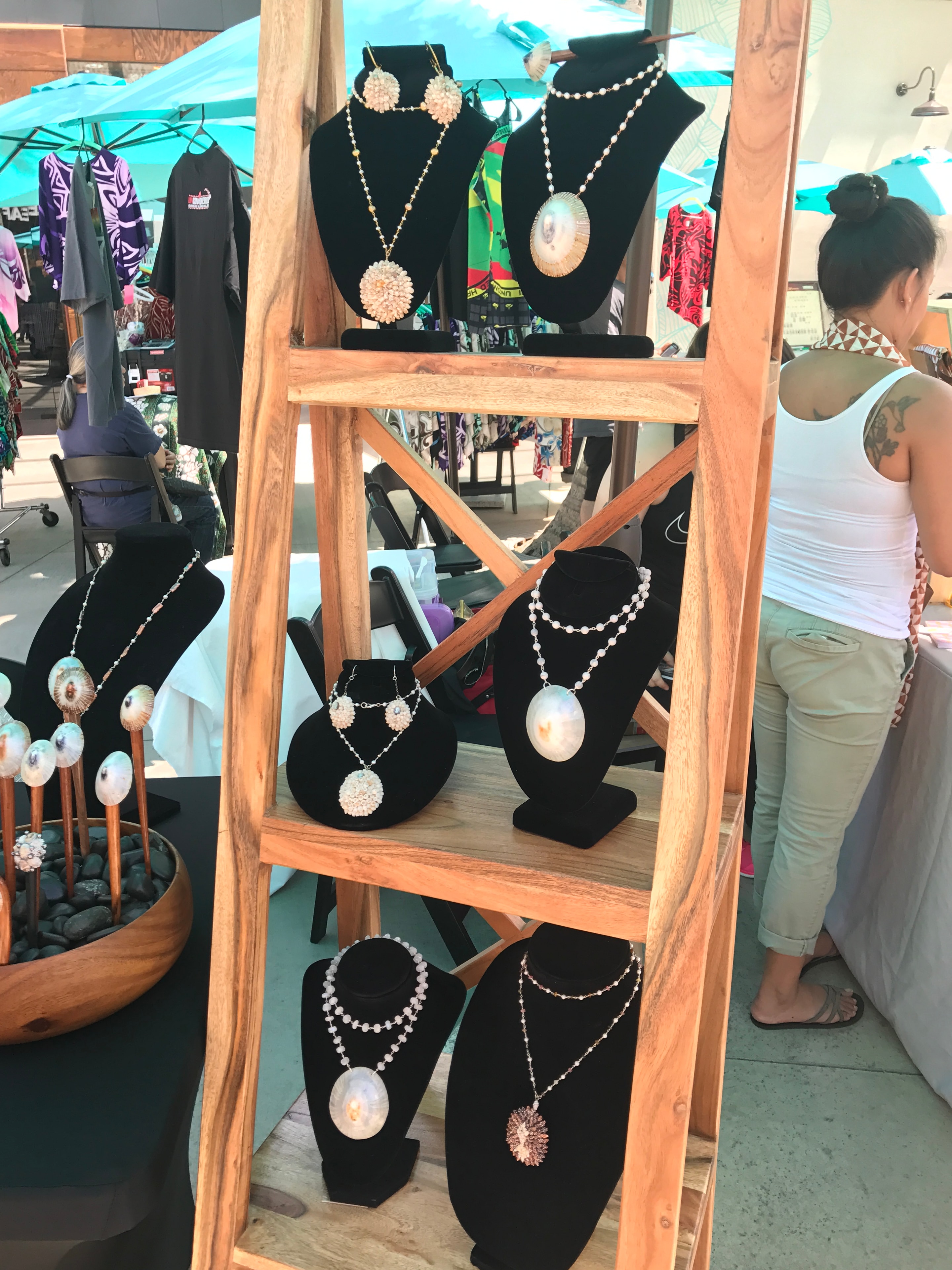 Shell and pearl necklaces displayed on black velvet busts
