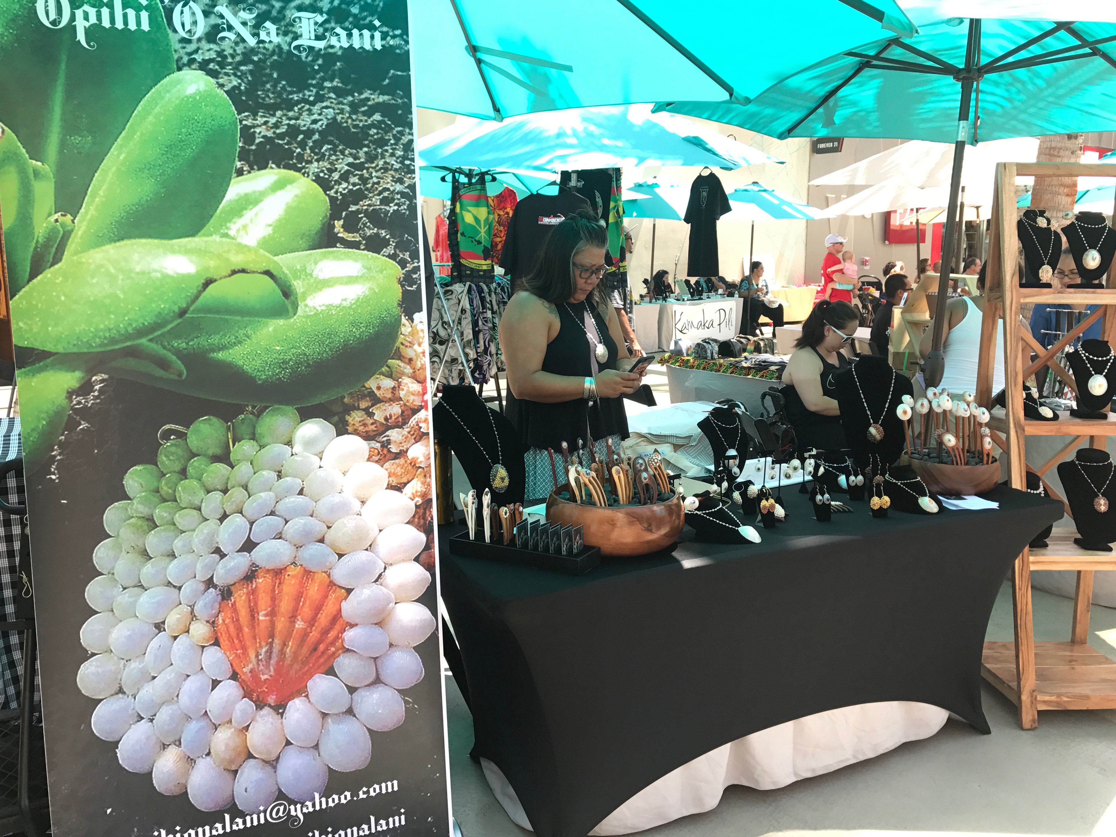 Opihi O Na Lani jewelry booth with Kamaka Pili banner in background