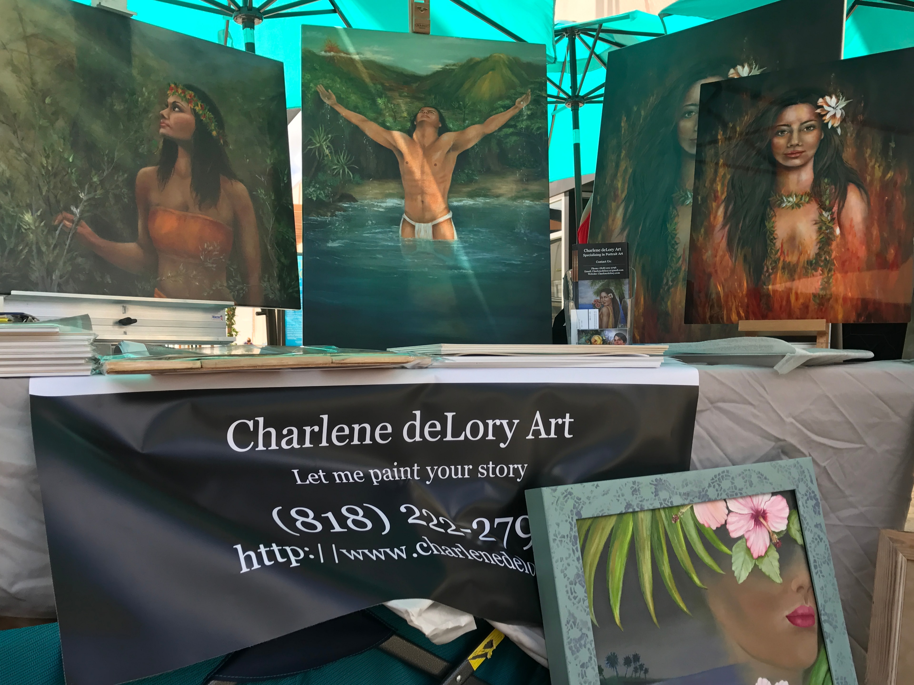 Charlene deLory Art display featuring tropical Hawaiian portrait paintings