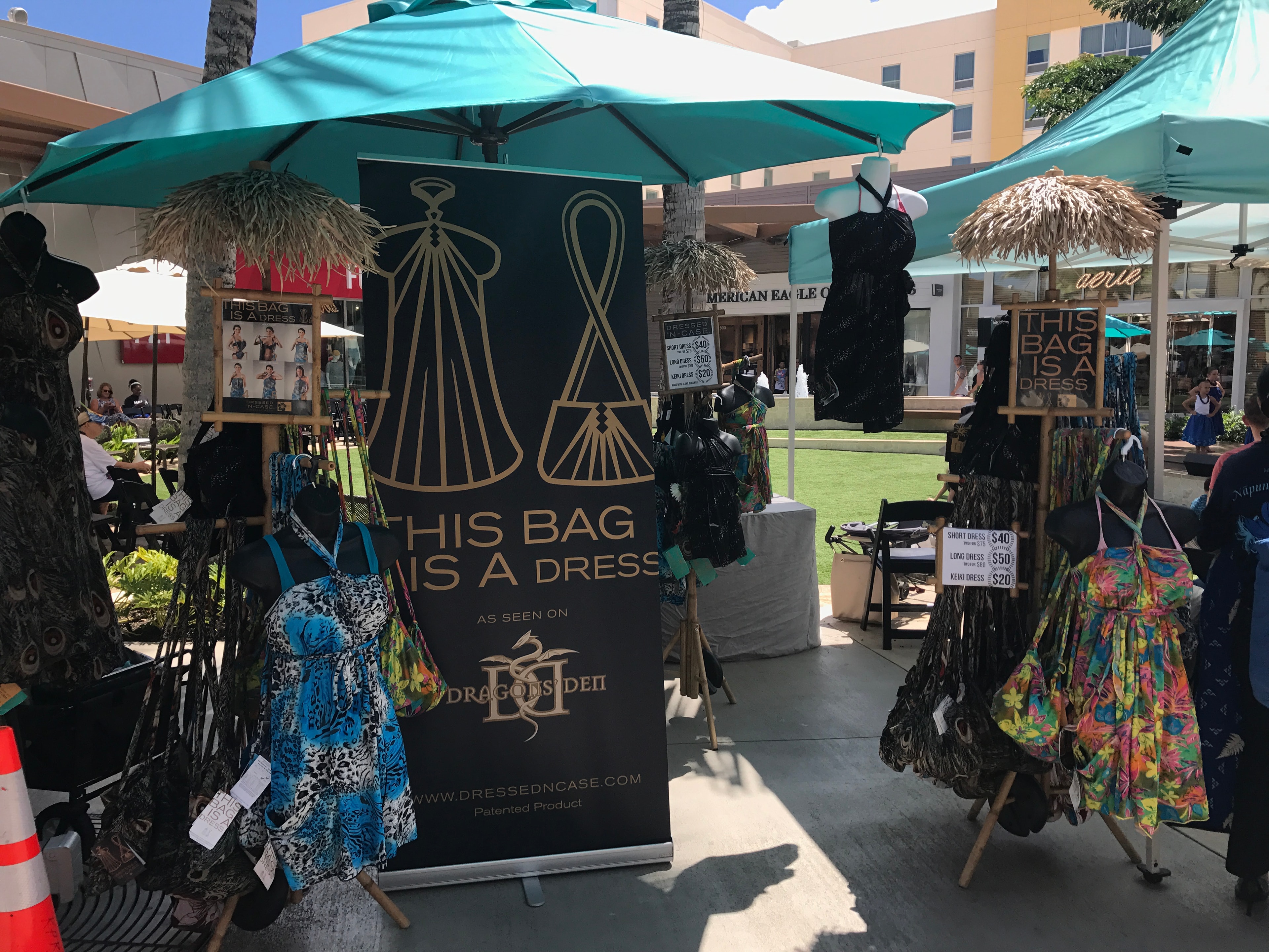 Dressed N Case vendor booth displaying convertible bag-dress fashion at outdoor market