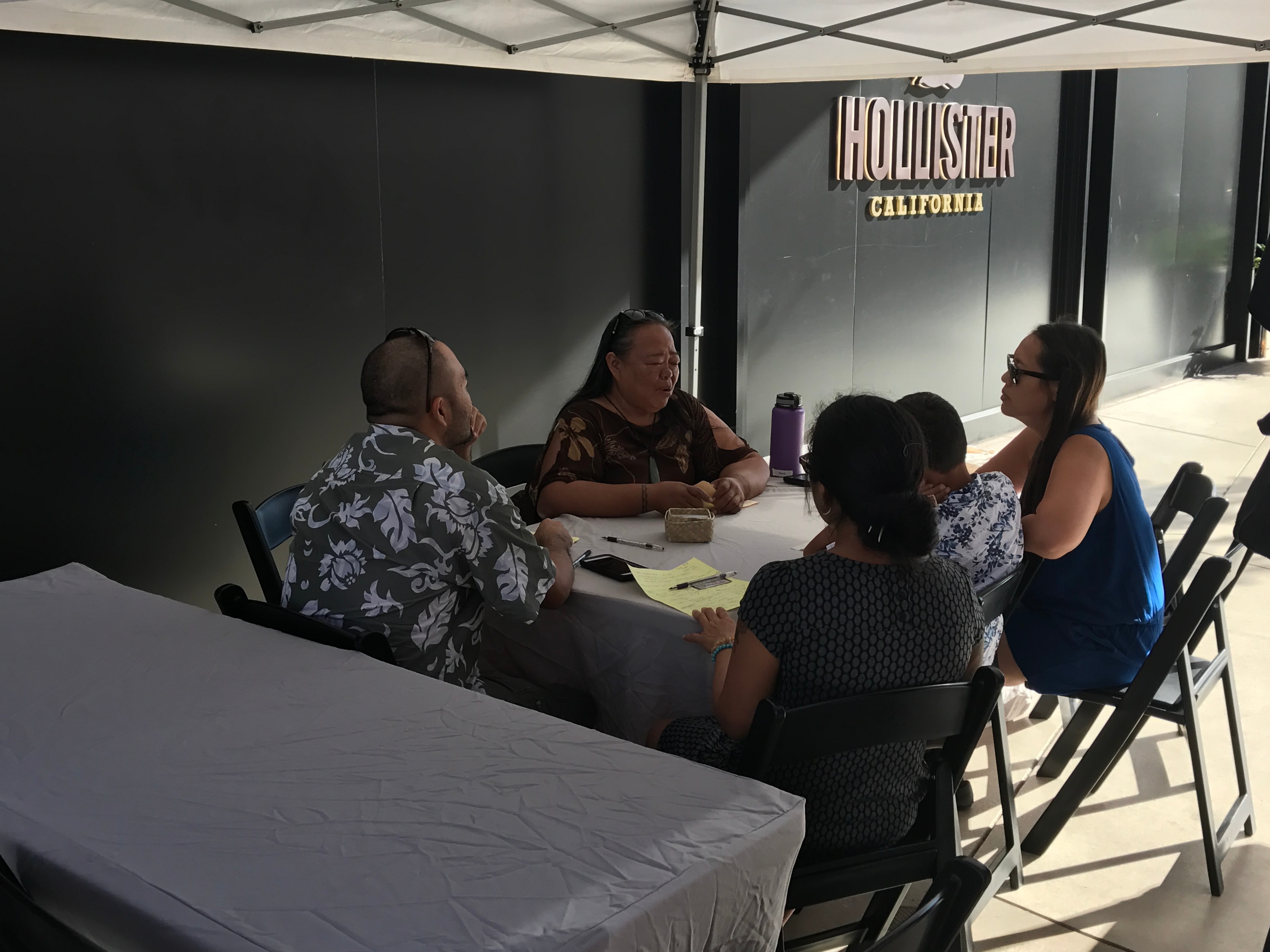 Group meeting under Hollister tent outdoors