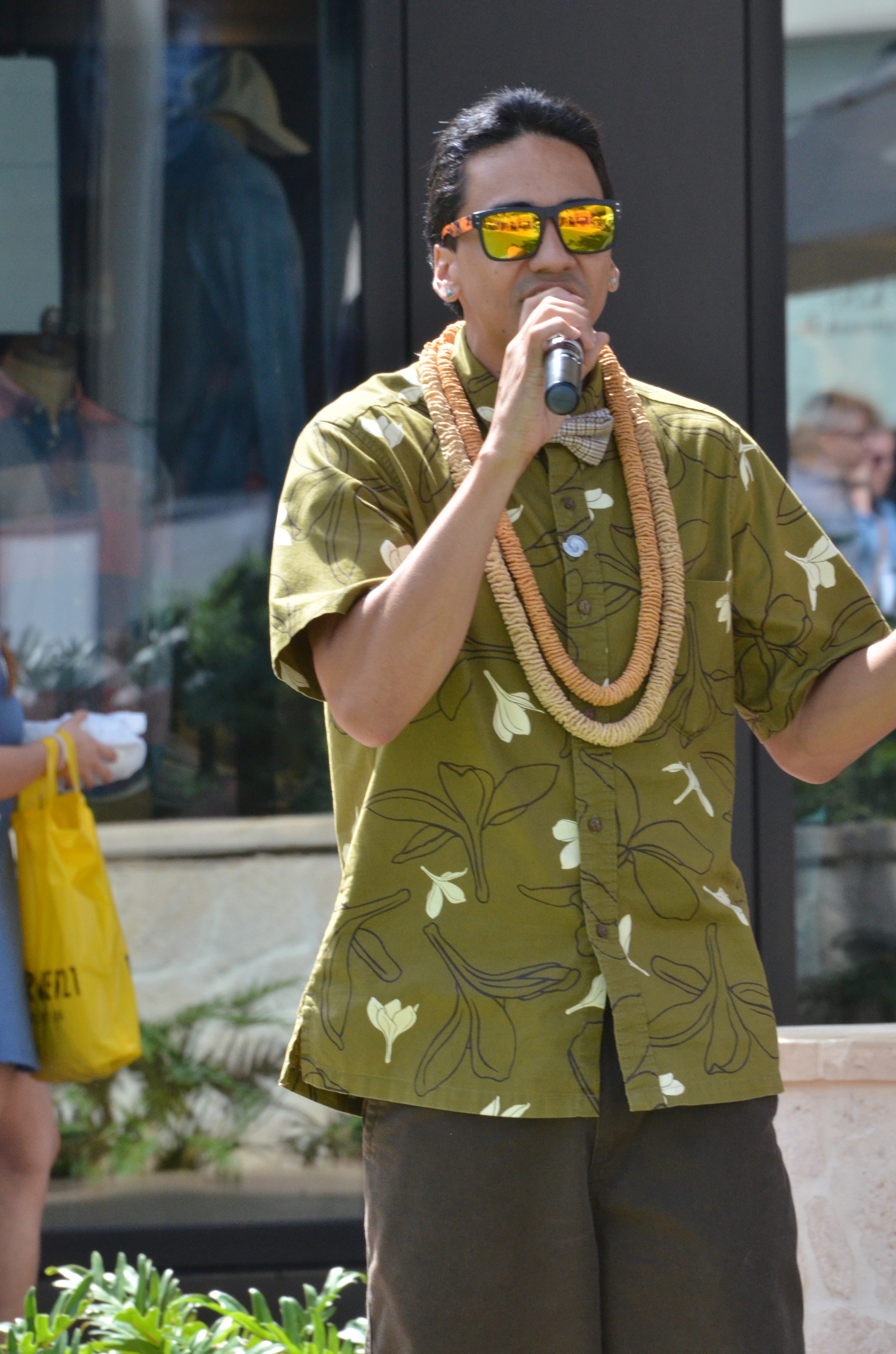 Man singing microphone Hawaiian shirt sunglasses
