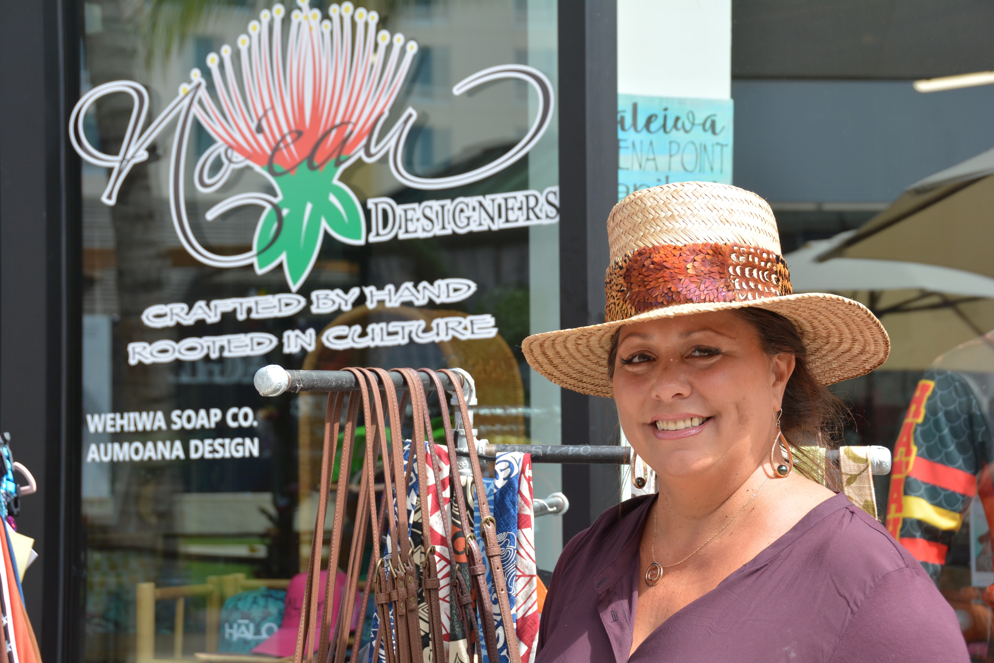 Woman wearing straw hat outside design shop