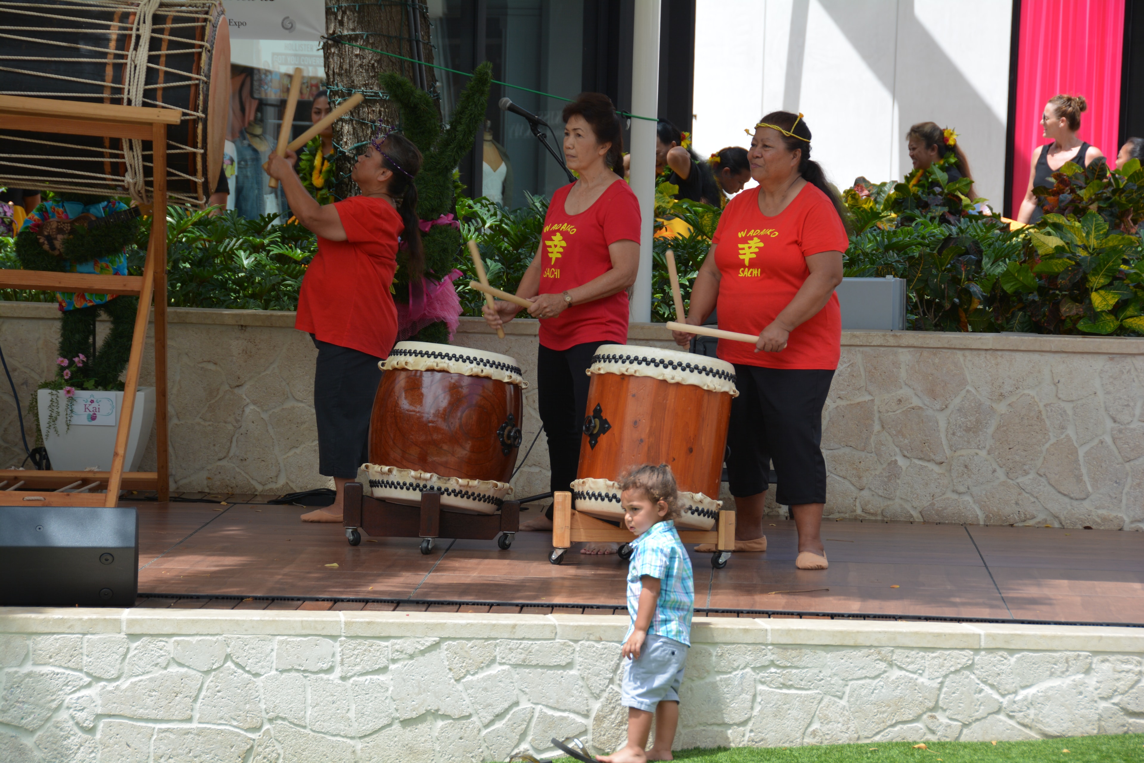 Performers playing taiko drums outdoor festival