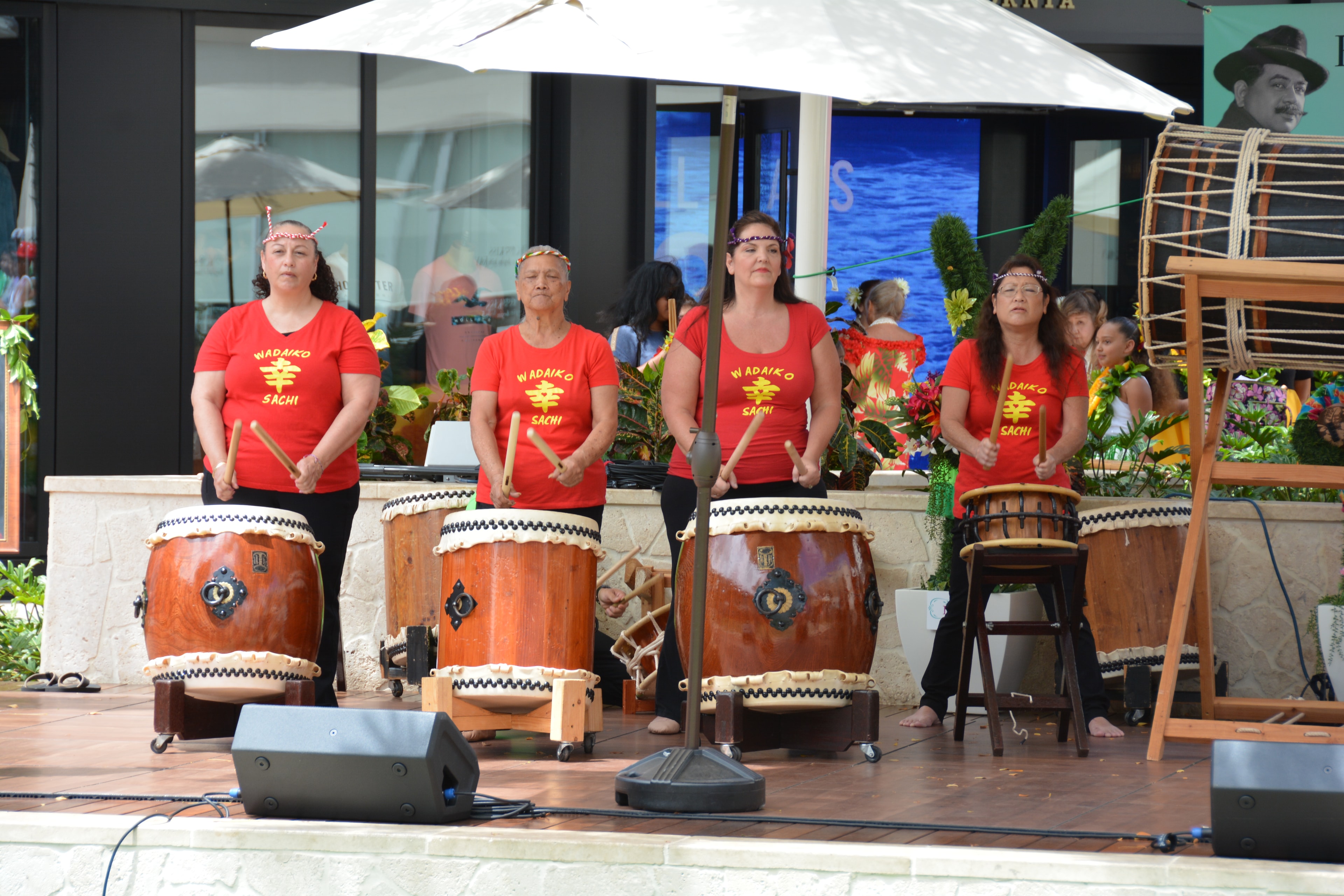 Women performing traditional taiko drum ensemble