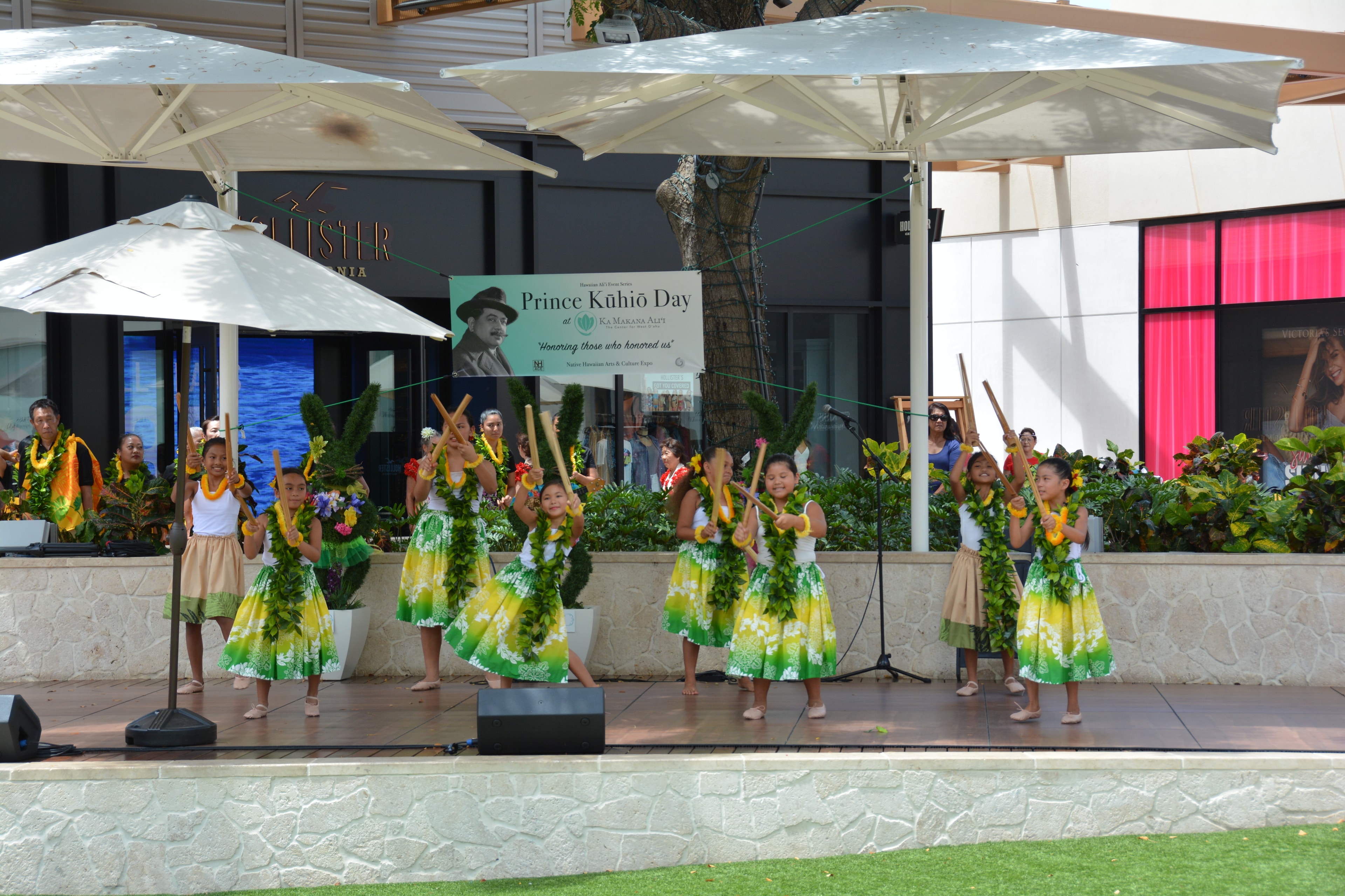 Children performing Hawaiian hula dance outdoor stage