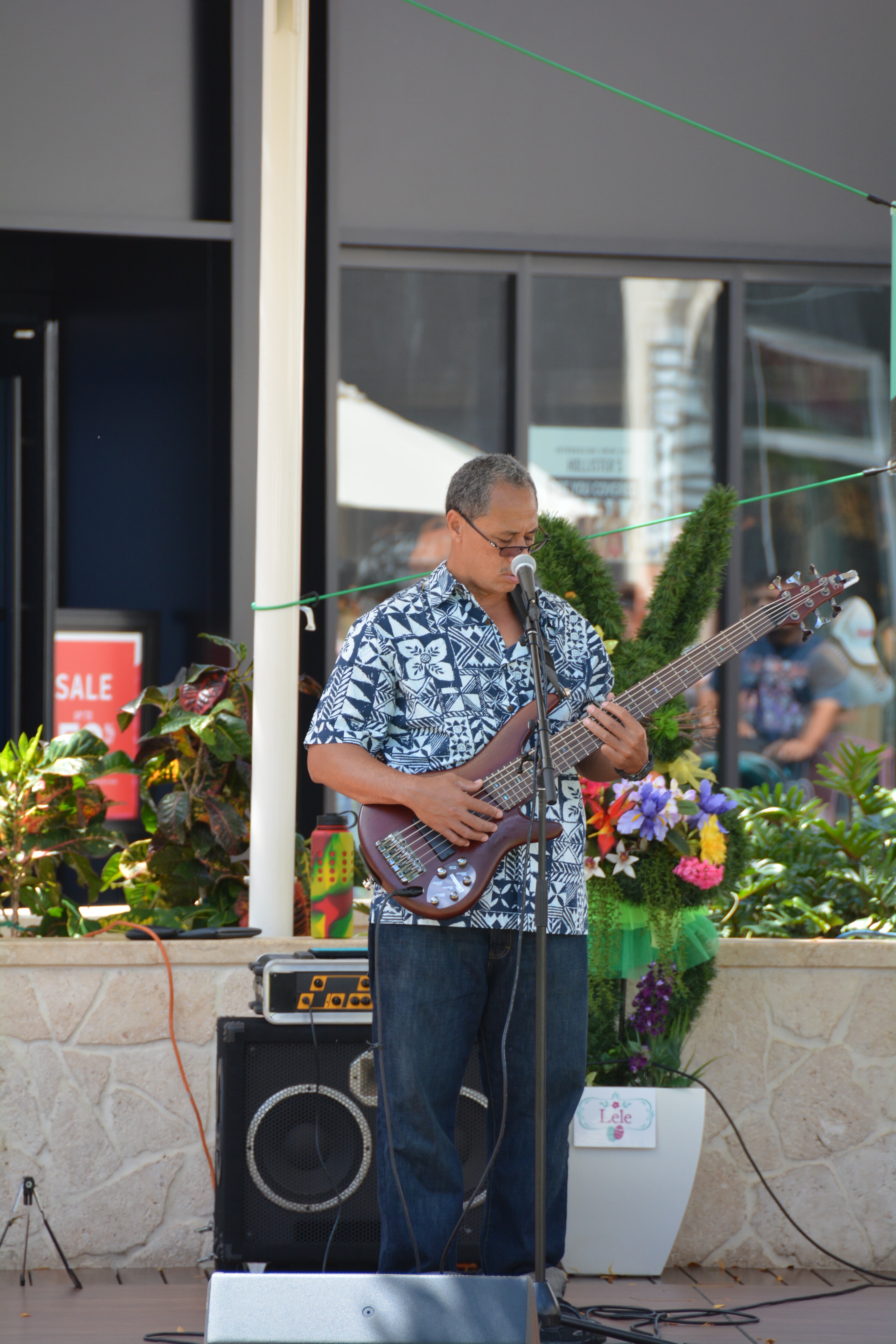 Musician performing bass guitar outdoors