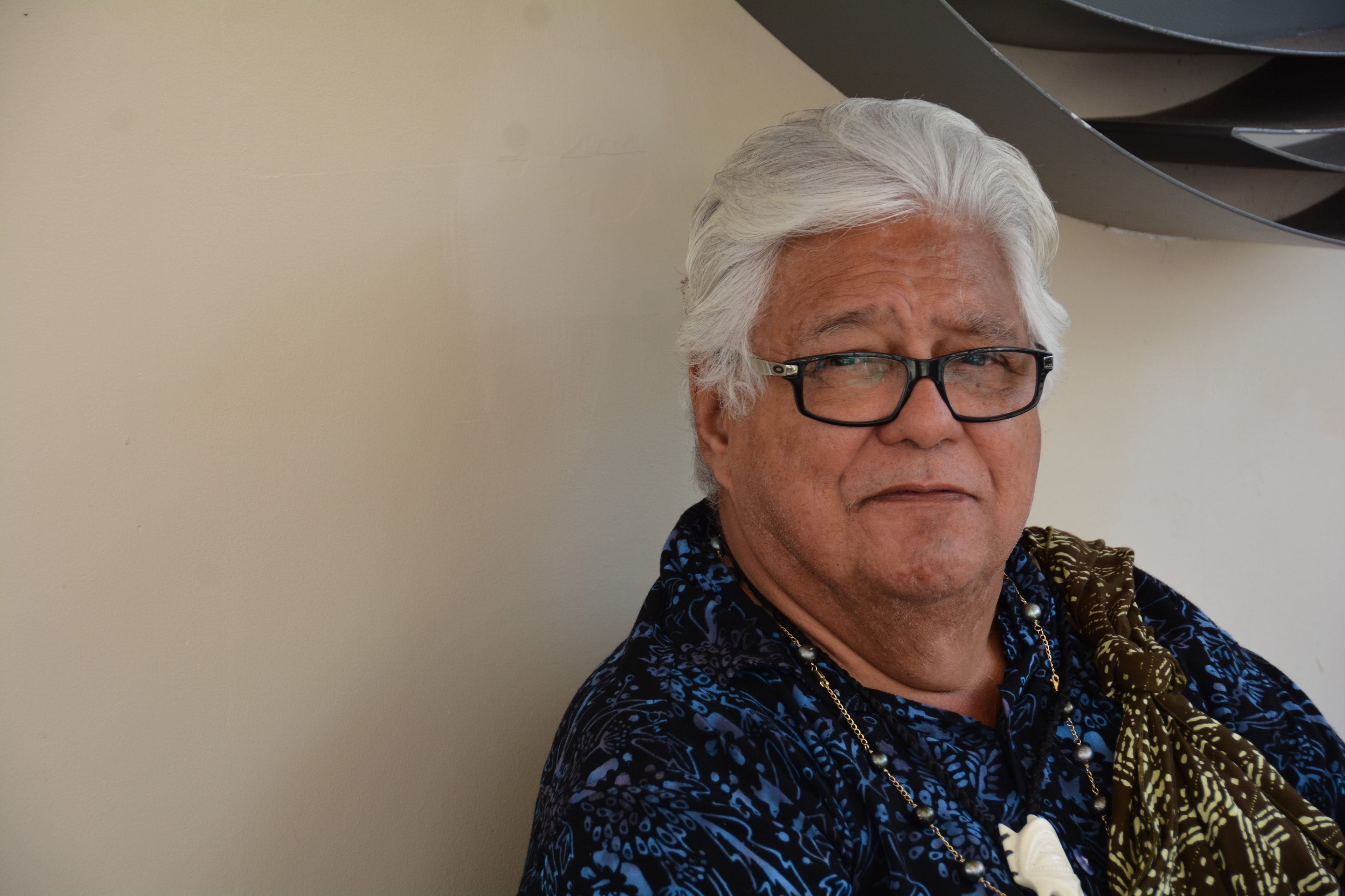 Older man wearing glasses and patterned jacket