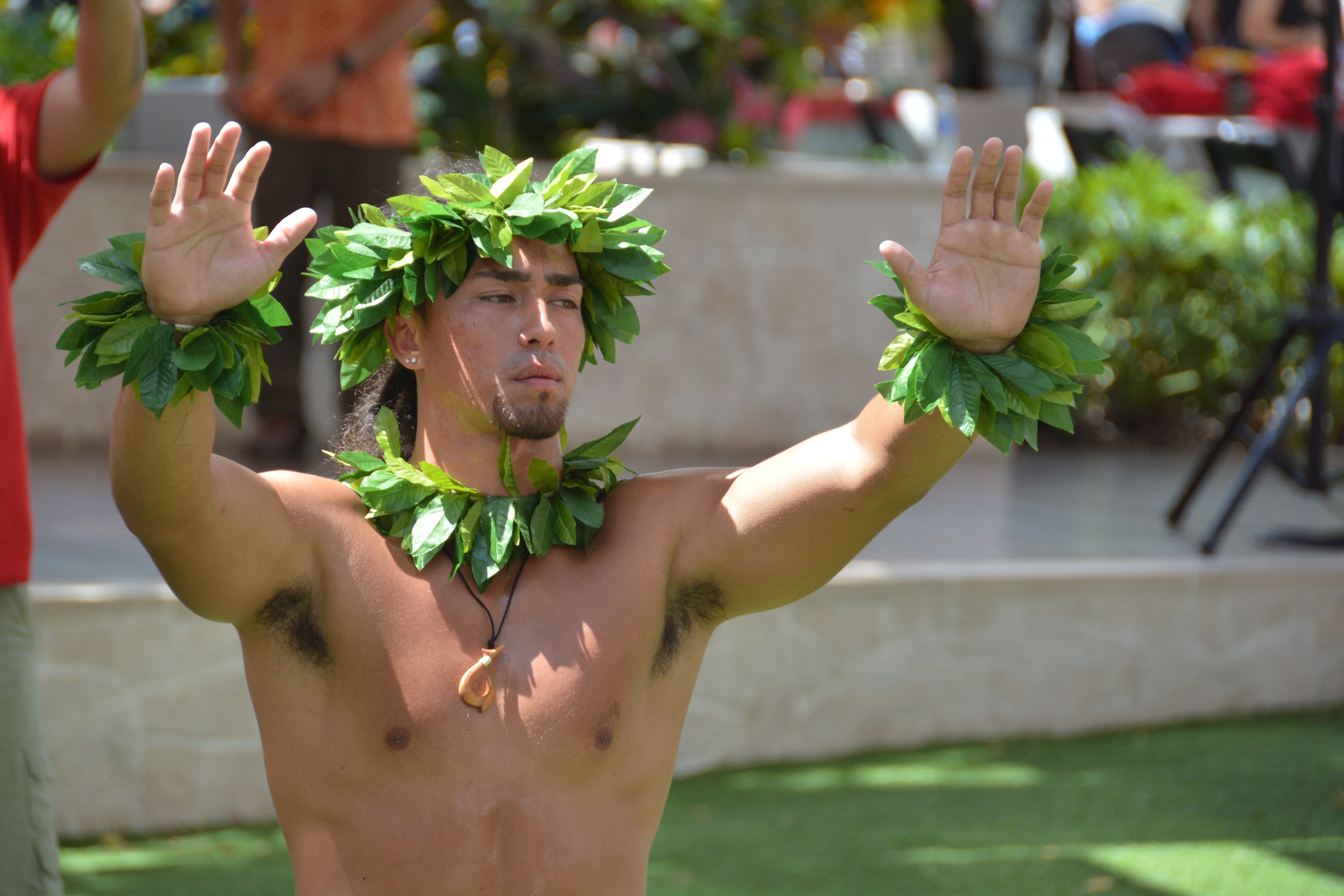 Man wearing lei garland performing Hawaiian dance at Prince Kūhiō Day