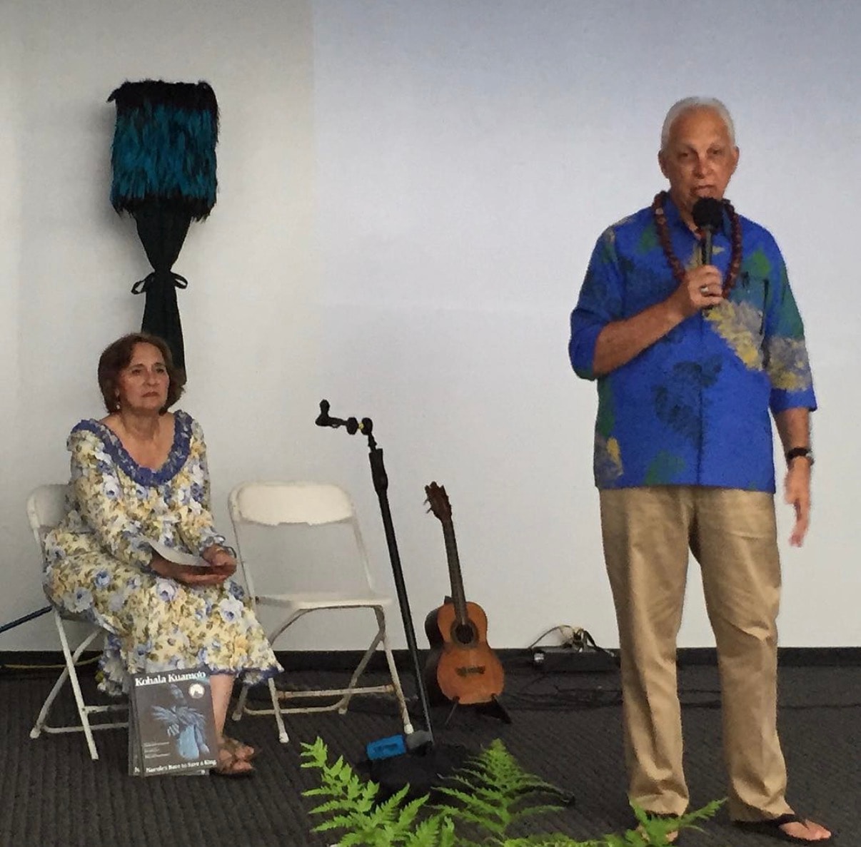 Man speaking at cultural art presentation event