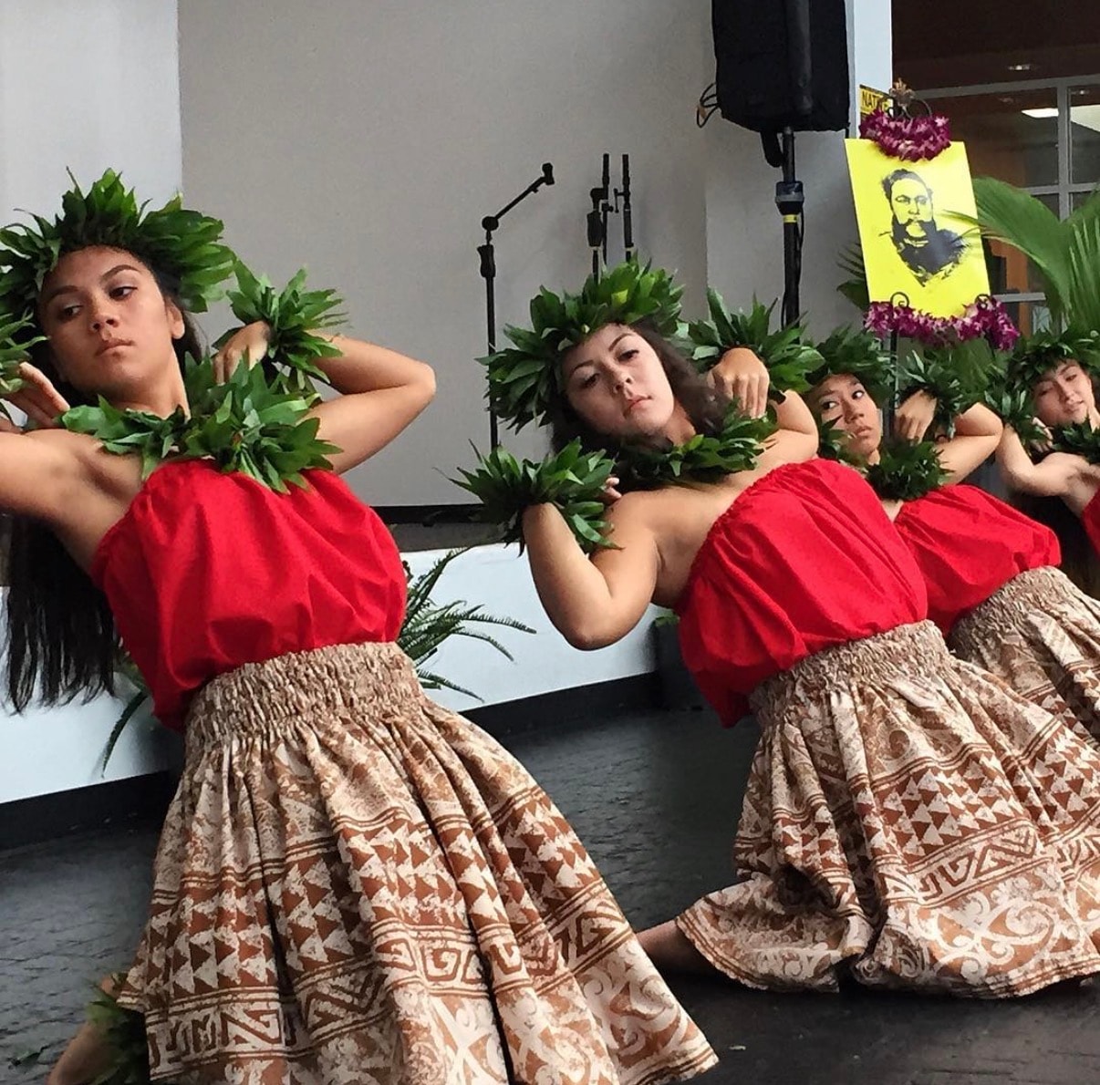 Performers in traditional Hawaiian costume posing