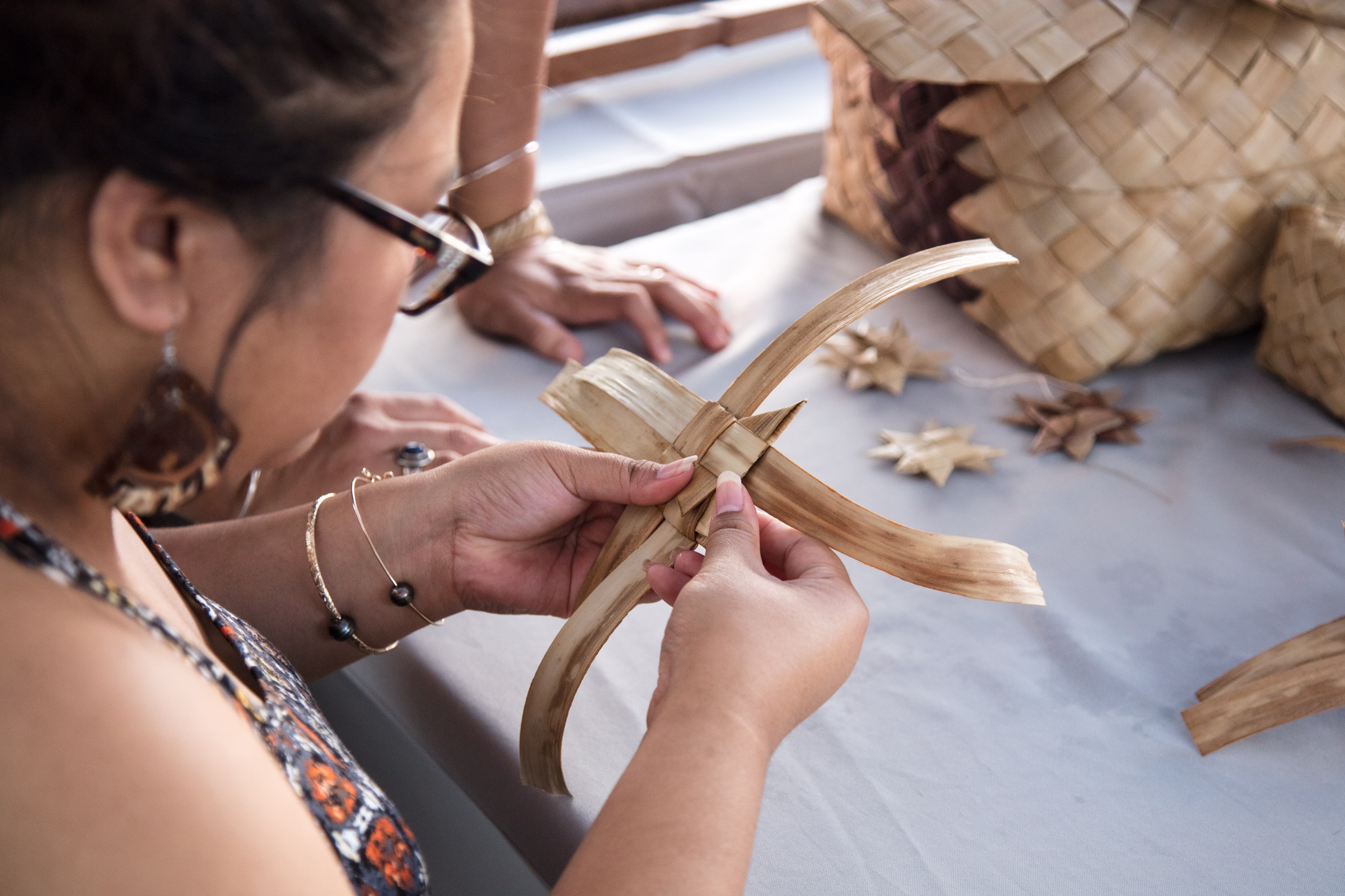 People carving wooden decorations together