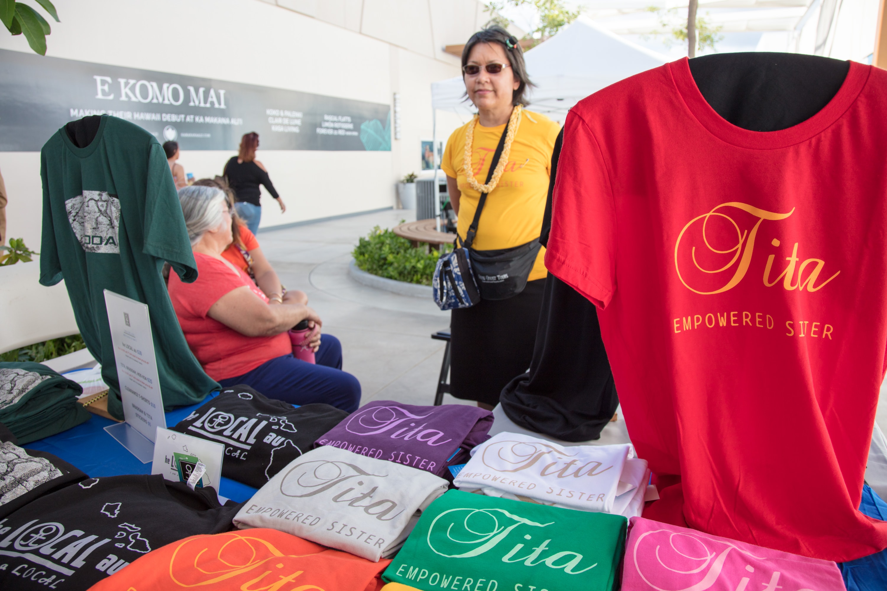Woman selling Empowered Sister branded t-shirts