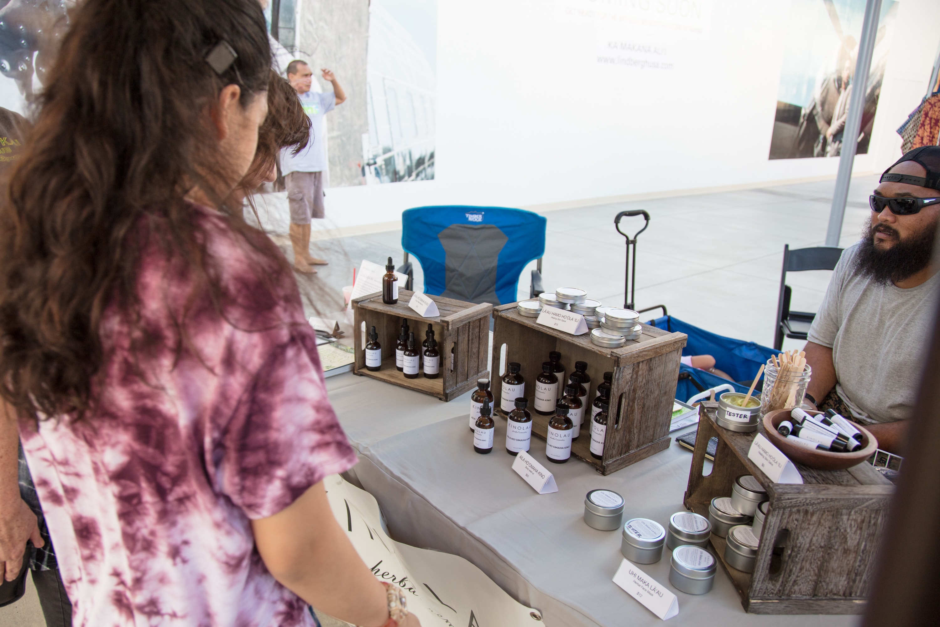 Vendor demonstrating skincare products at market