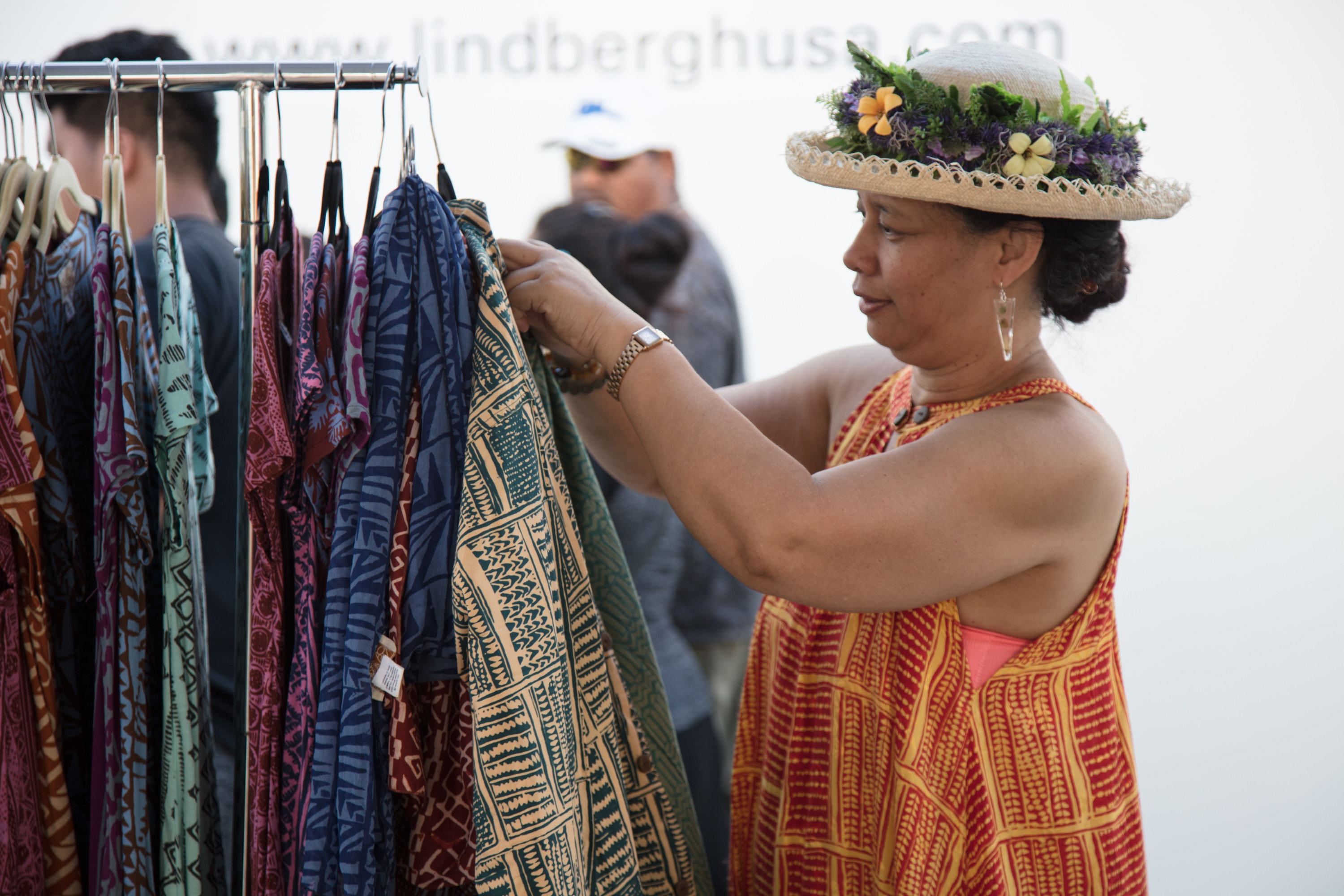 Woman browsing colorful patterned fabrics outdoors