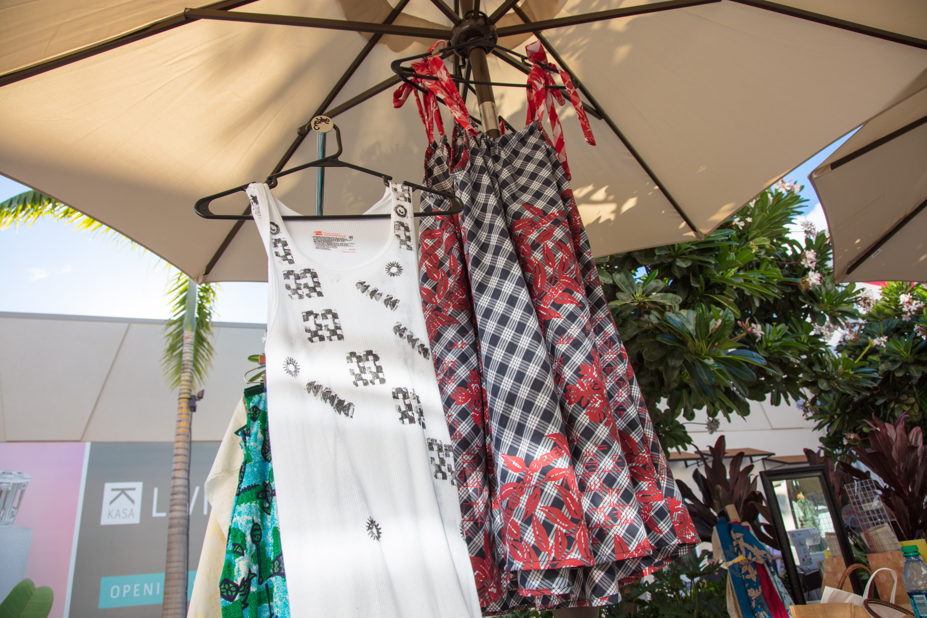 Clothes hanging under umbrella display