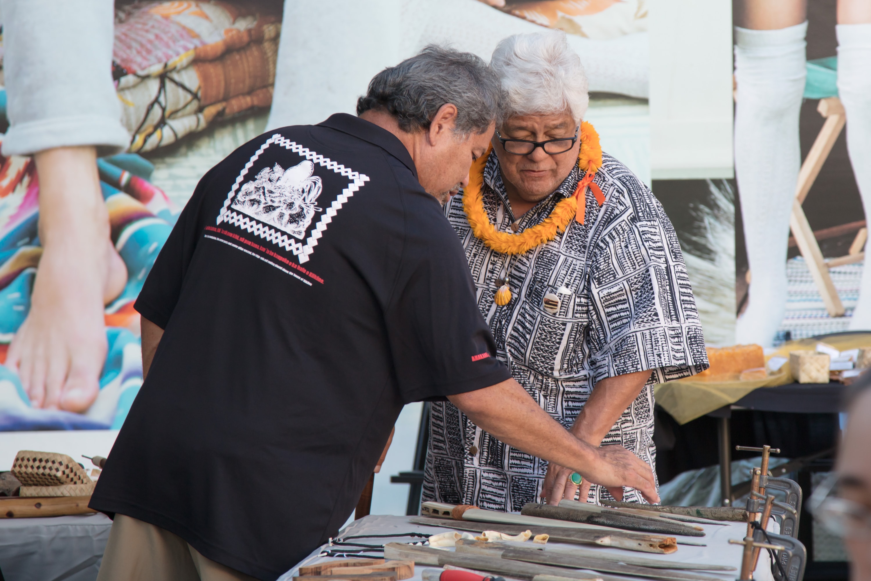 Elder woman teaching woodcarving craft workshop