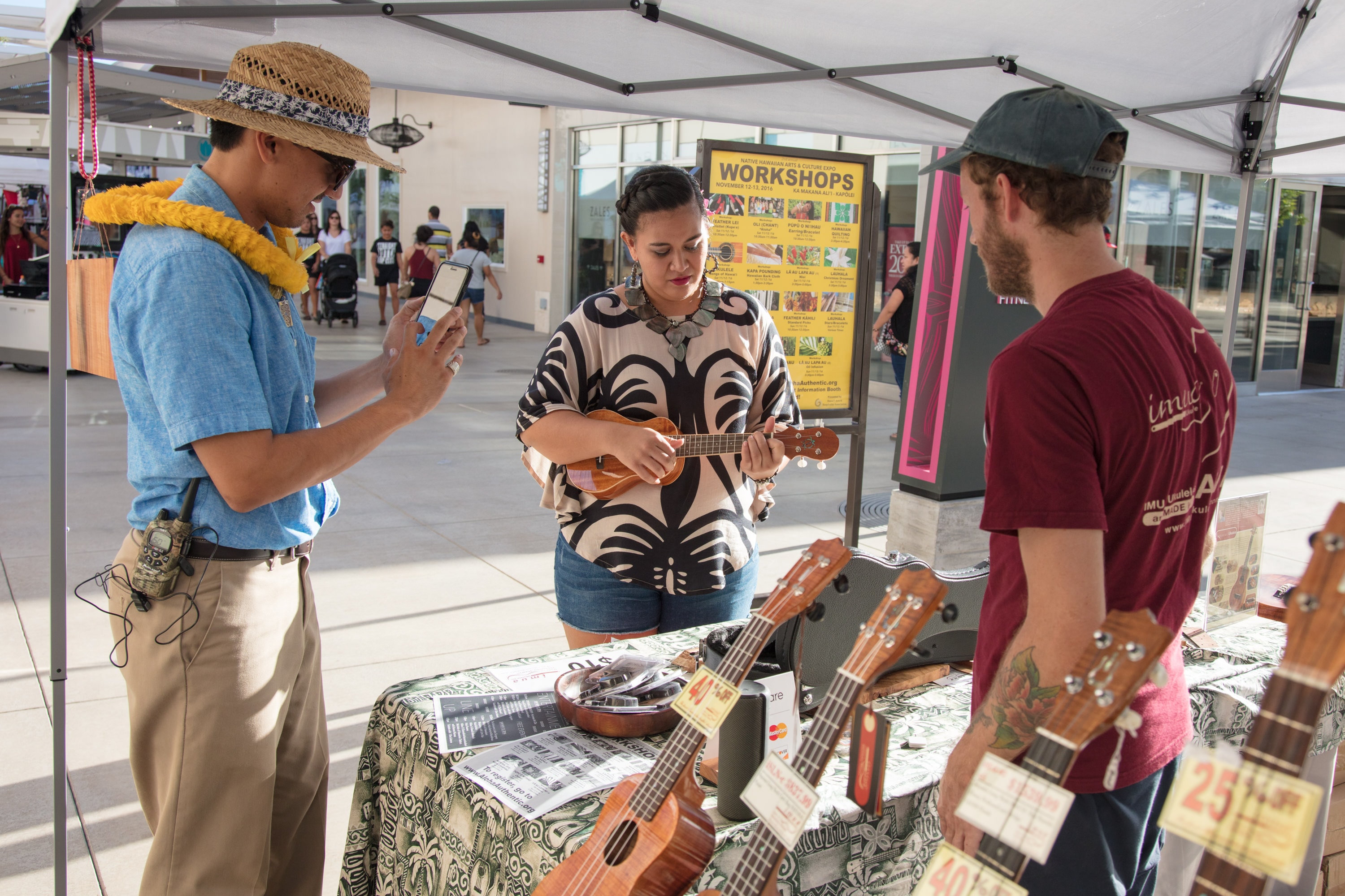 Woman playing ukulele at outdoor market booth