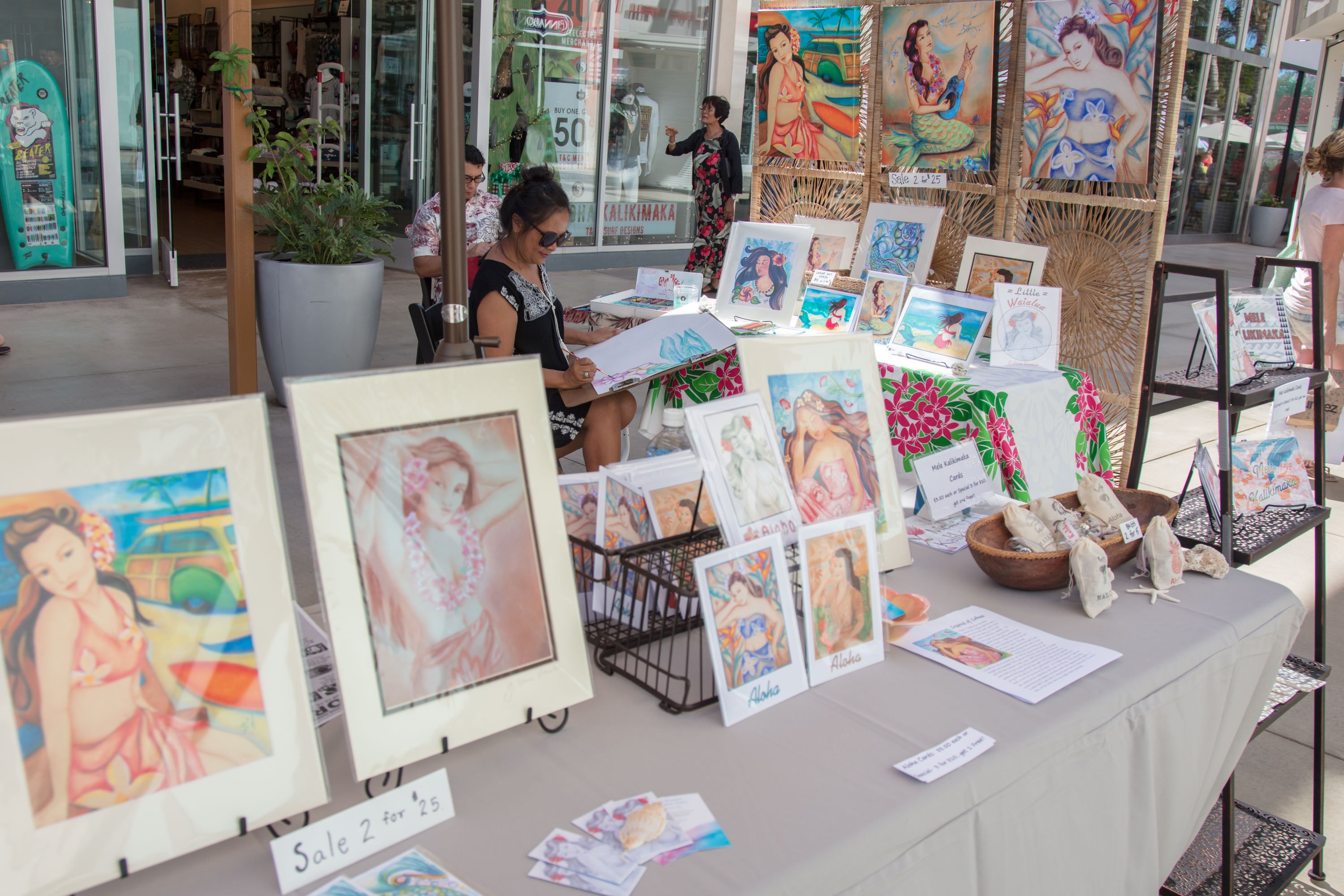 Artist selling colorful portrait paintings street