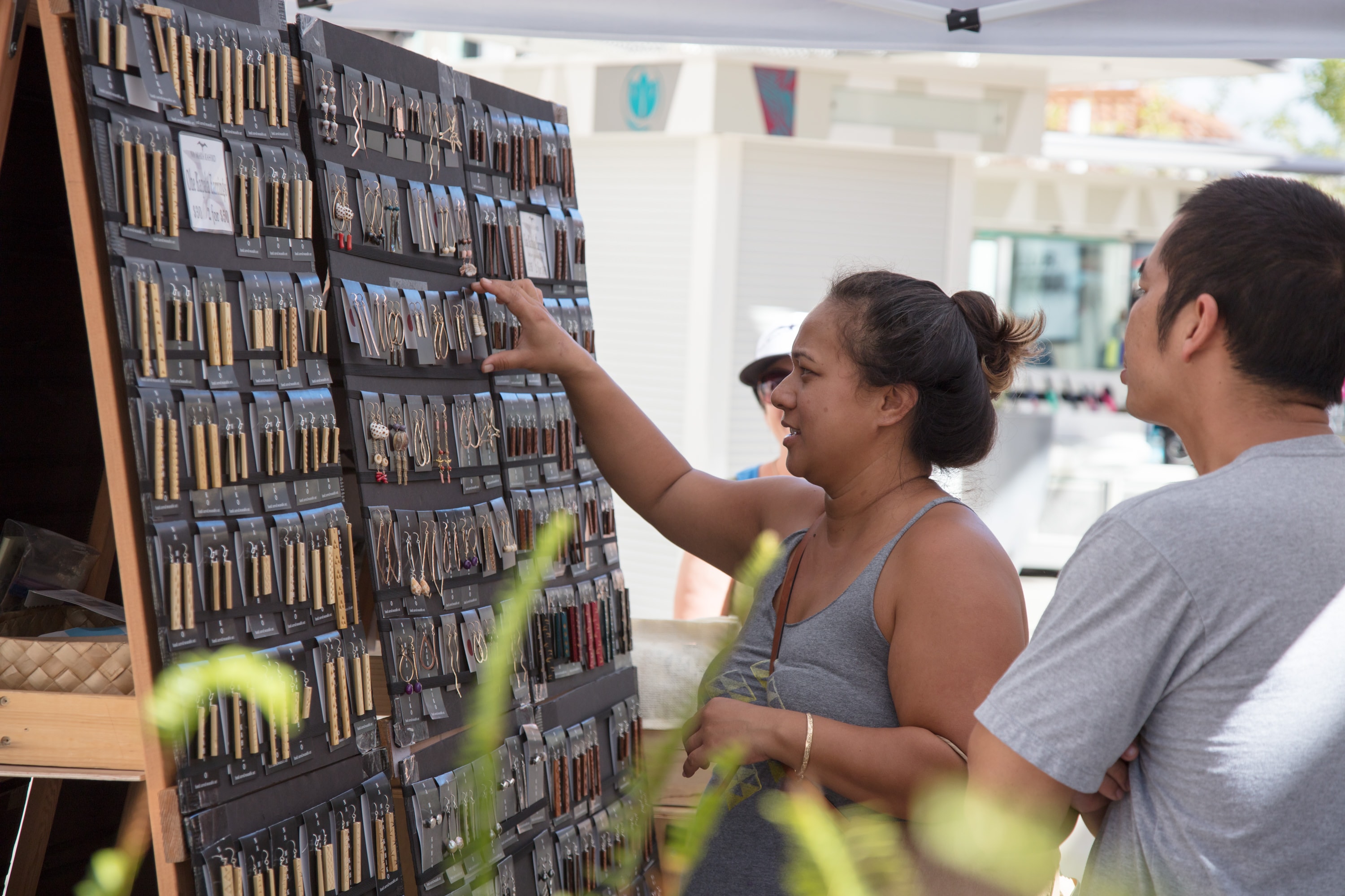 Customers browsing jewelry display wall