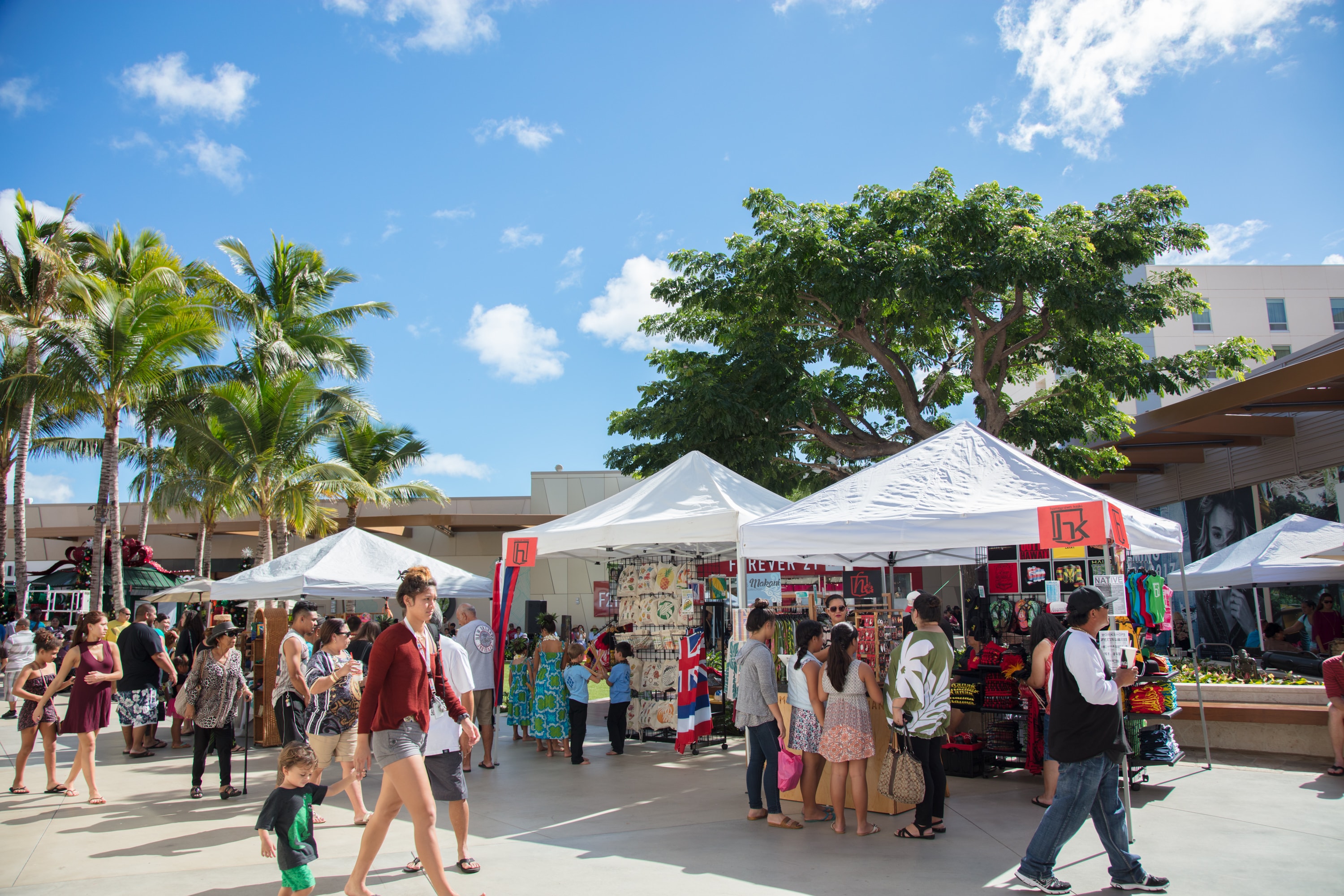 Outdoor market festival with white tents