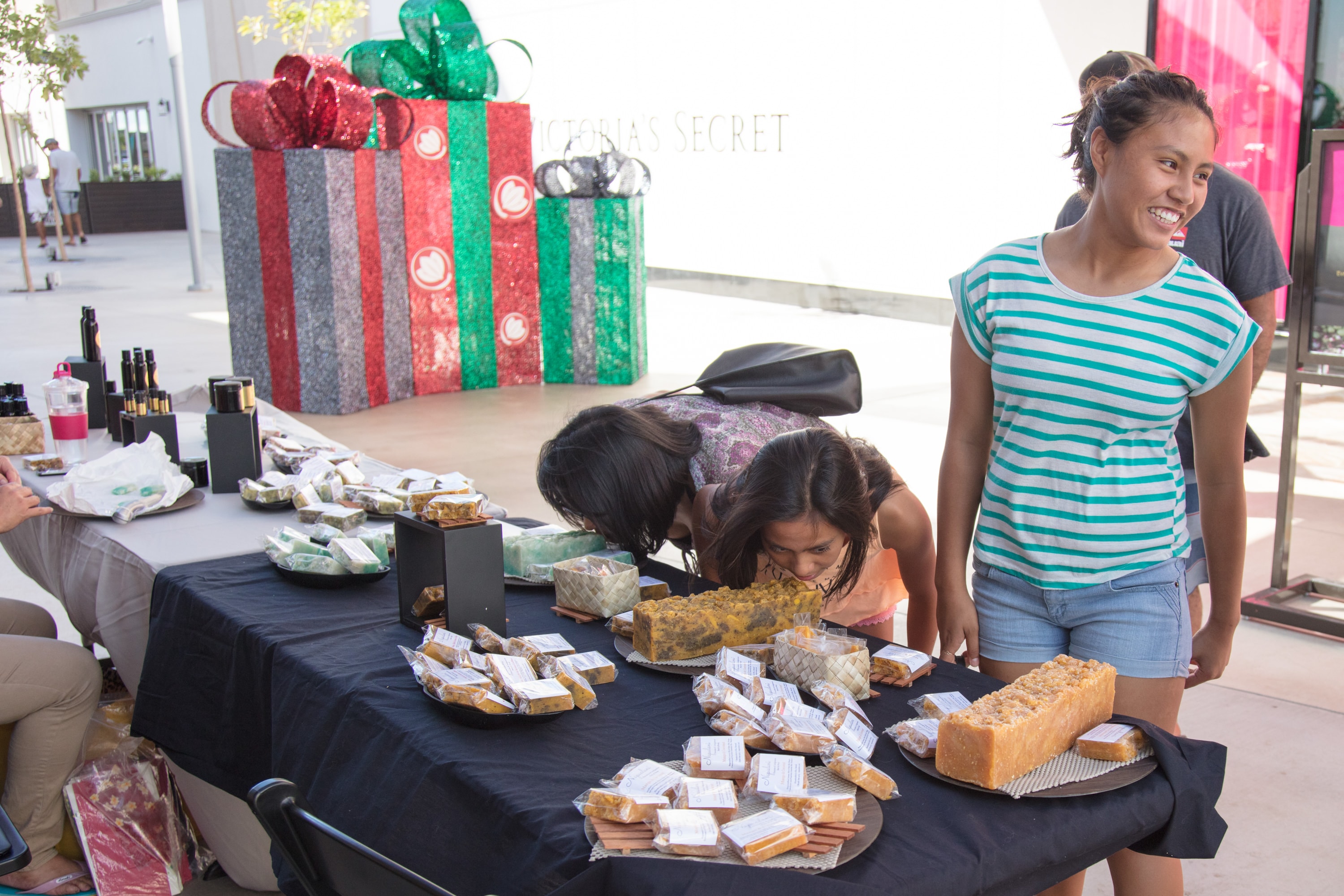 Women selling baked goods at market stall
