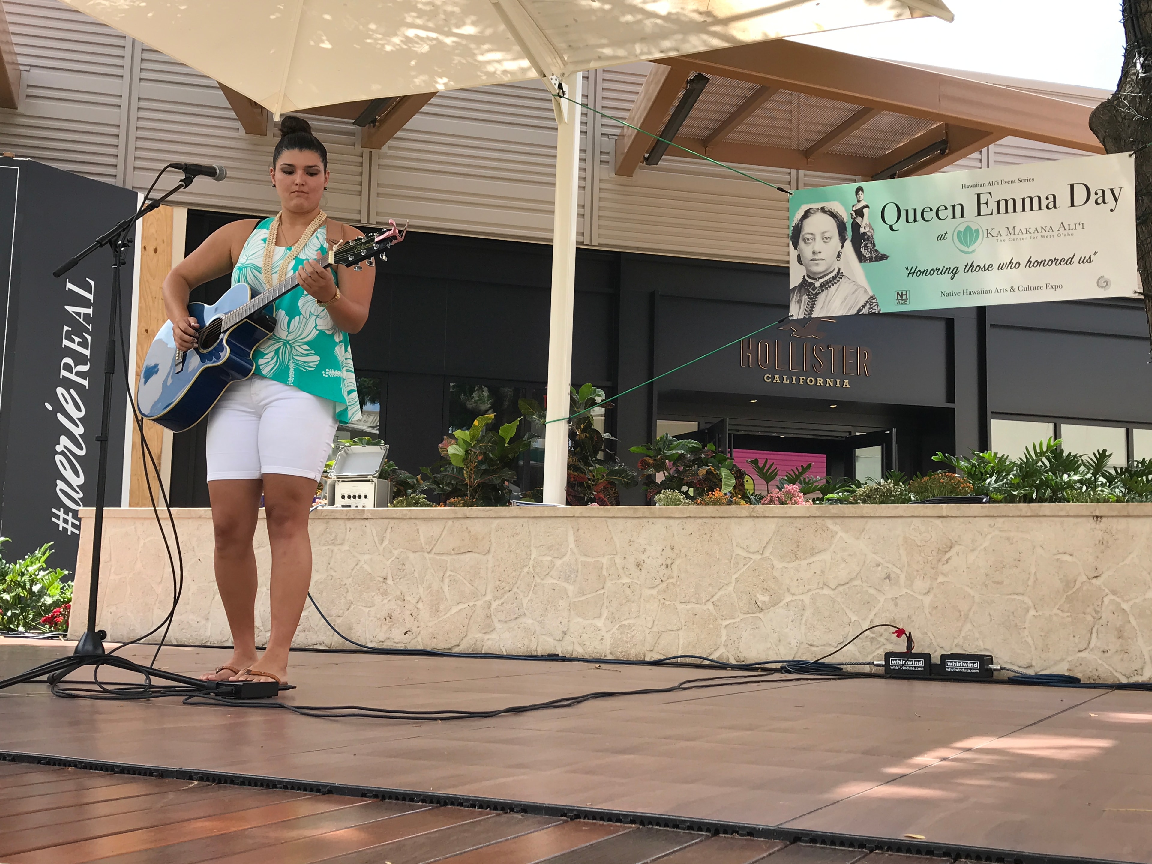 Woman performing guitar at outdoor event