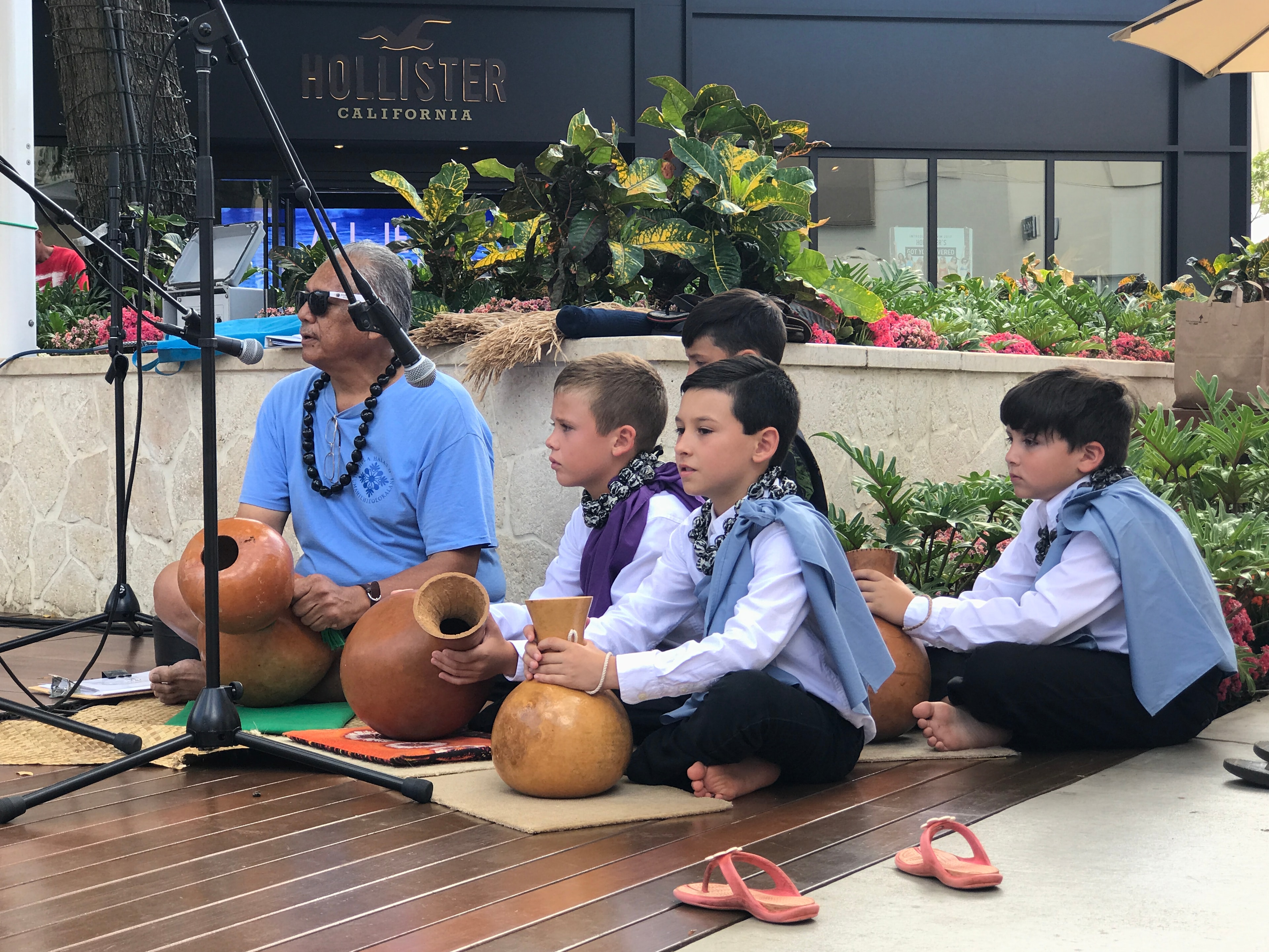 Man teaching children indigenous cultural demonstration