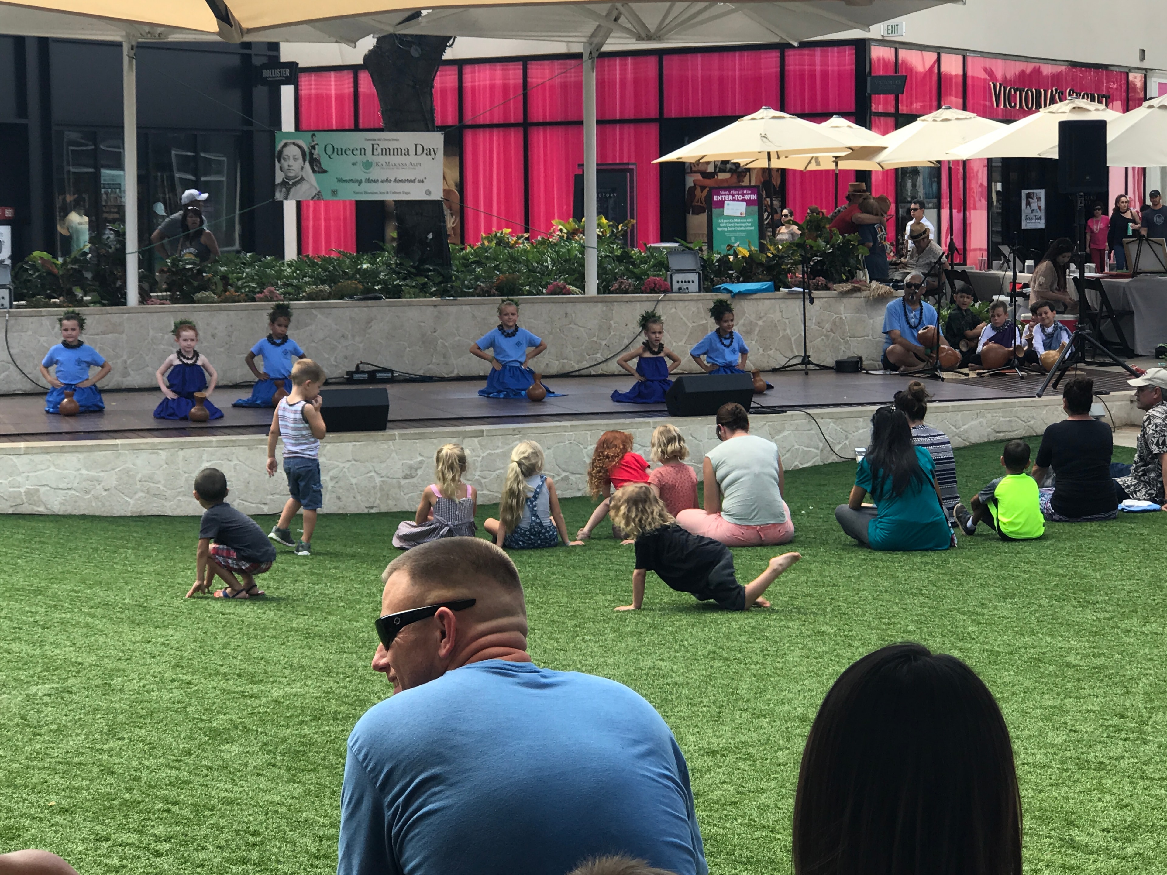 Children performing dance on outdoor stage