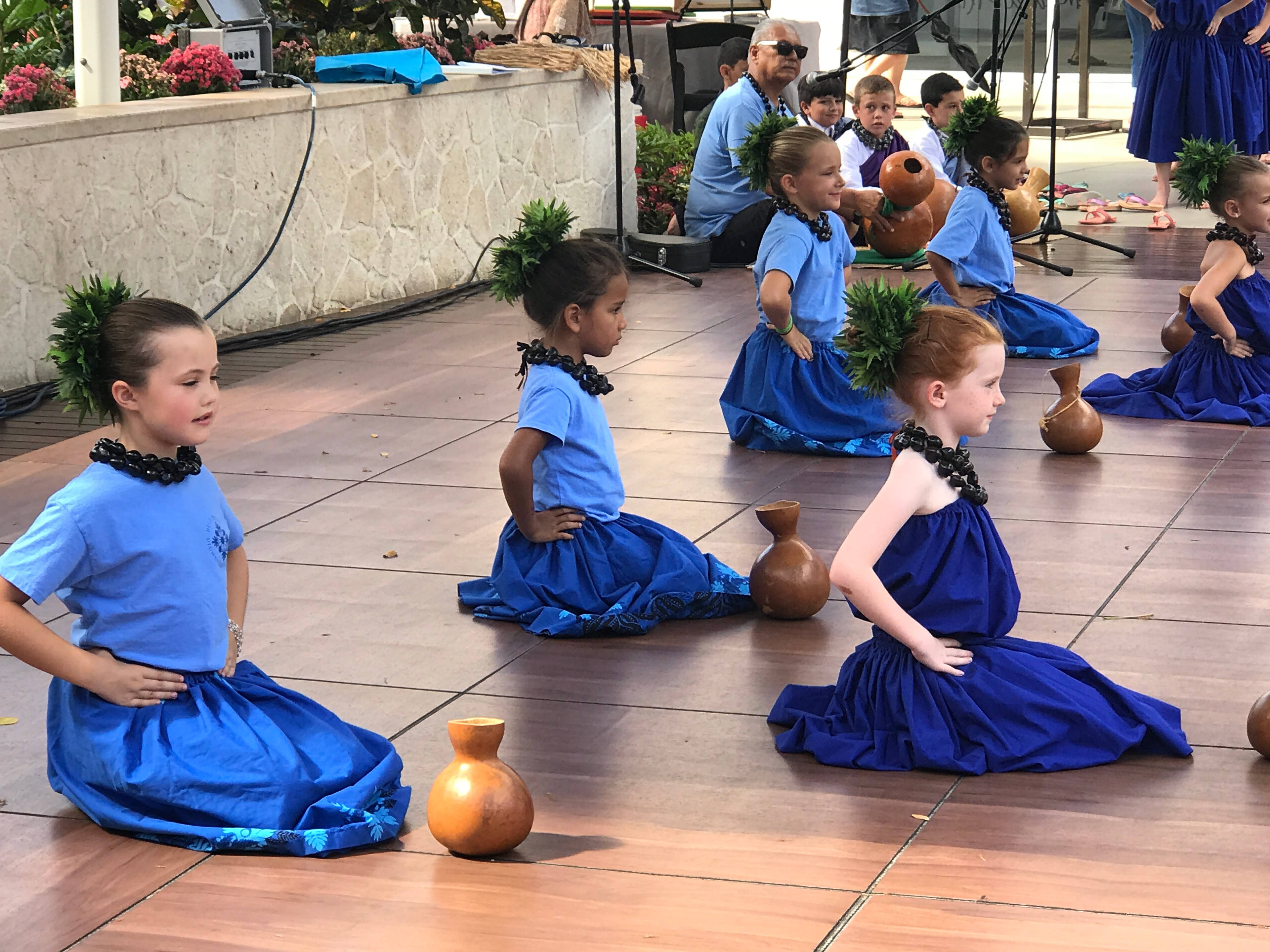 Children performing cultural dance with props
