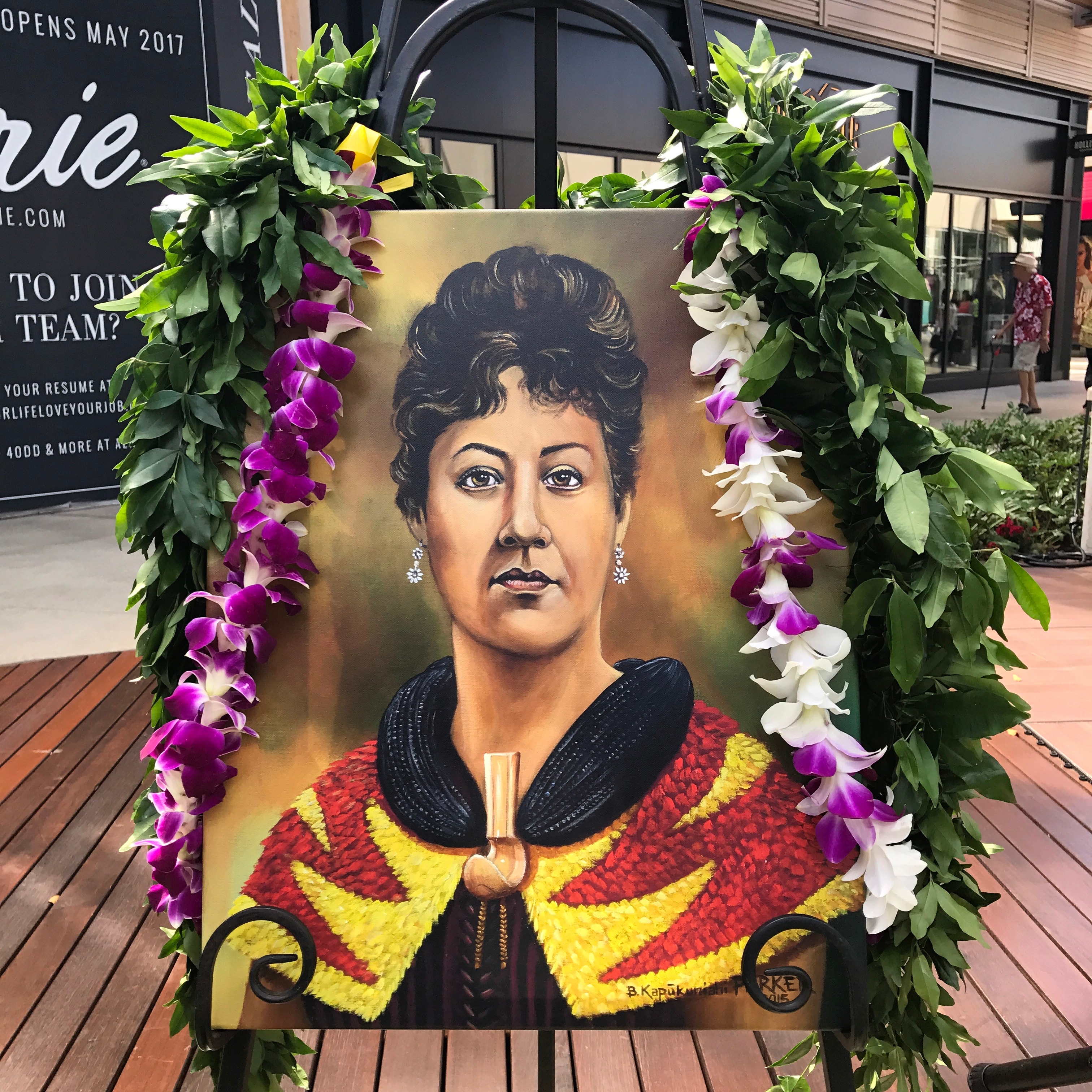 Portrait painting framed with orchid garland