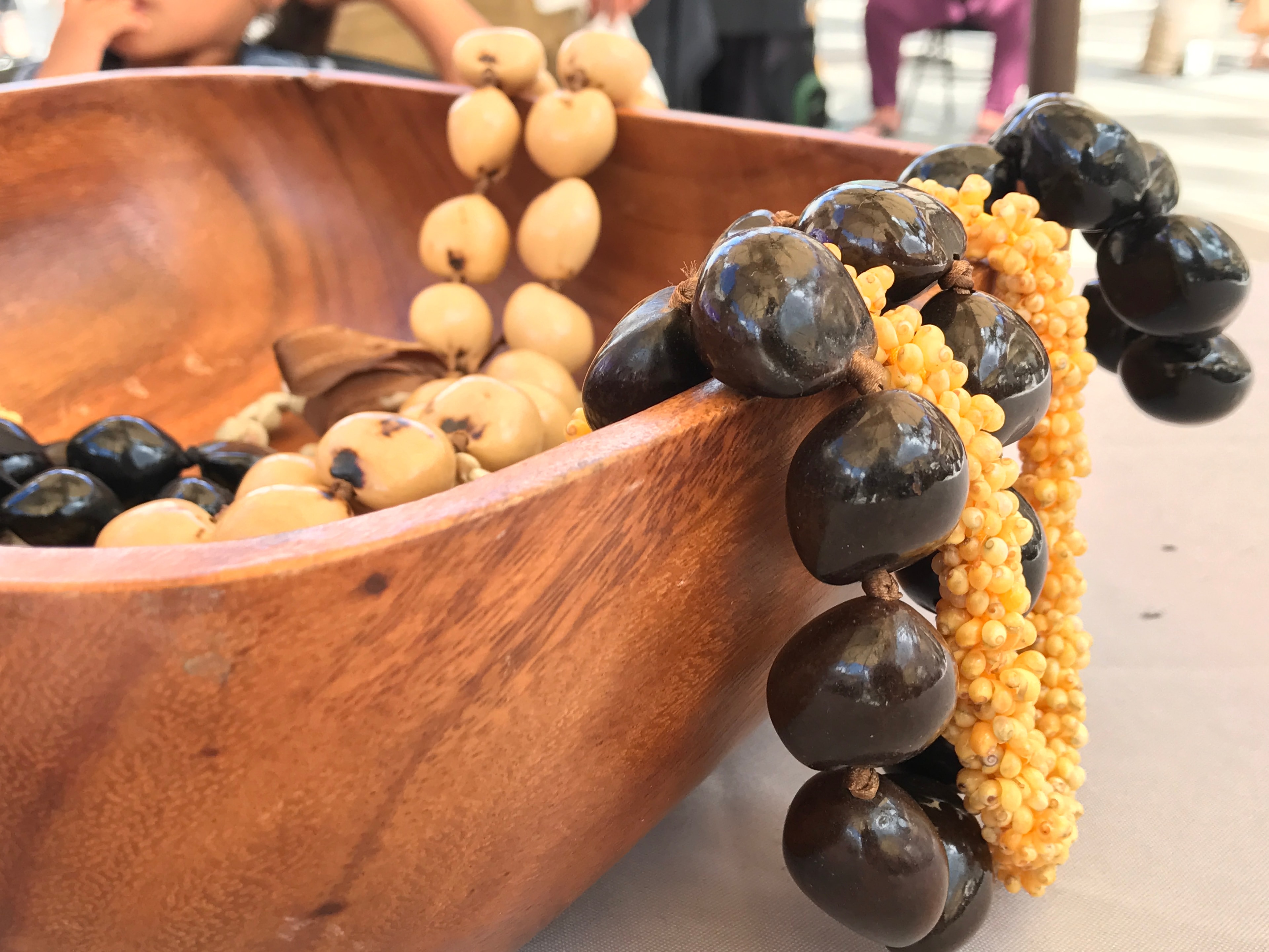 Beaded necklaces wooden bowl display