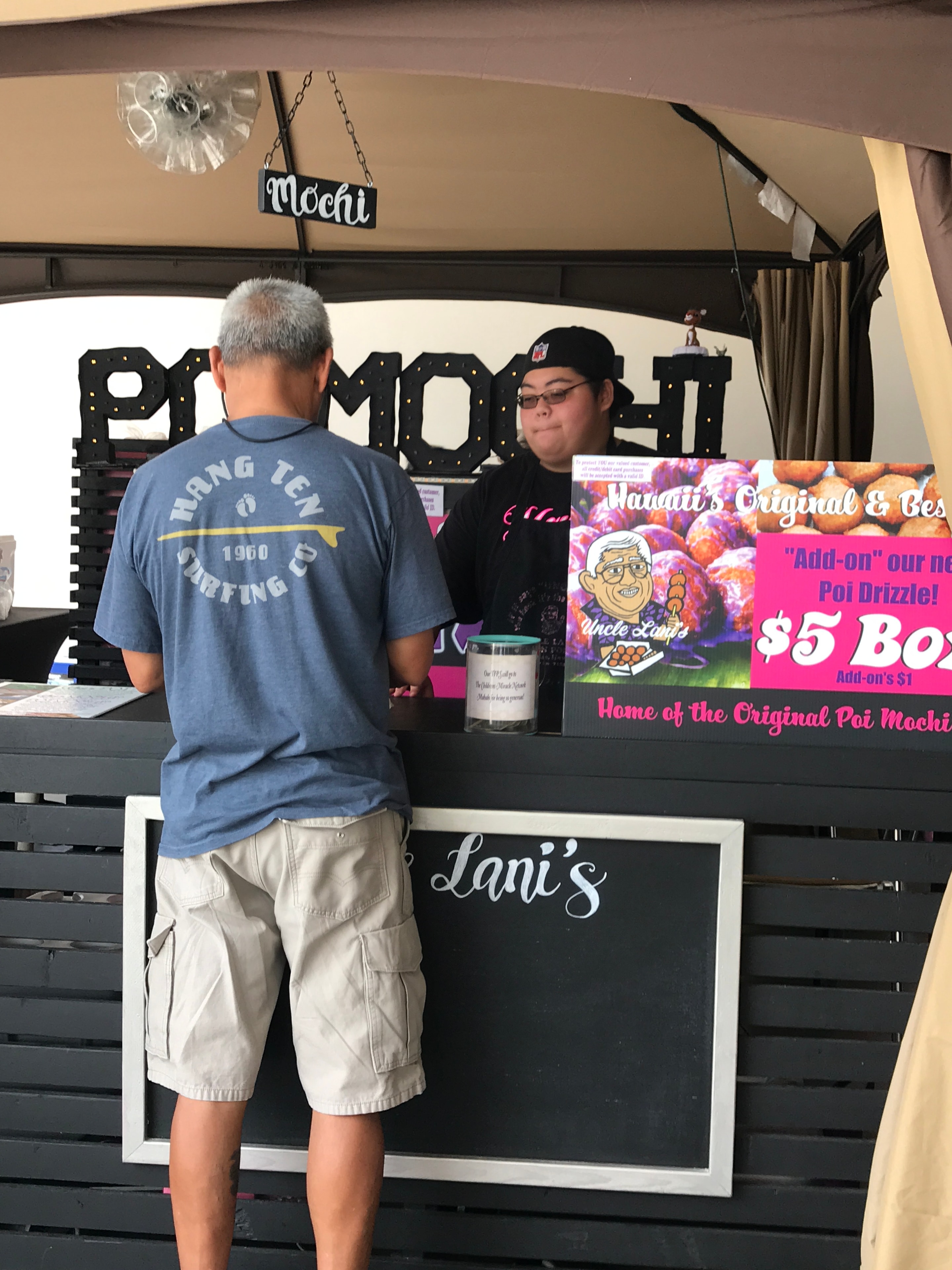 Customer ordering at mochi food stand