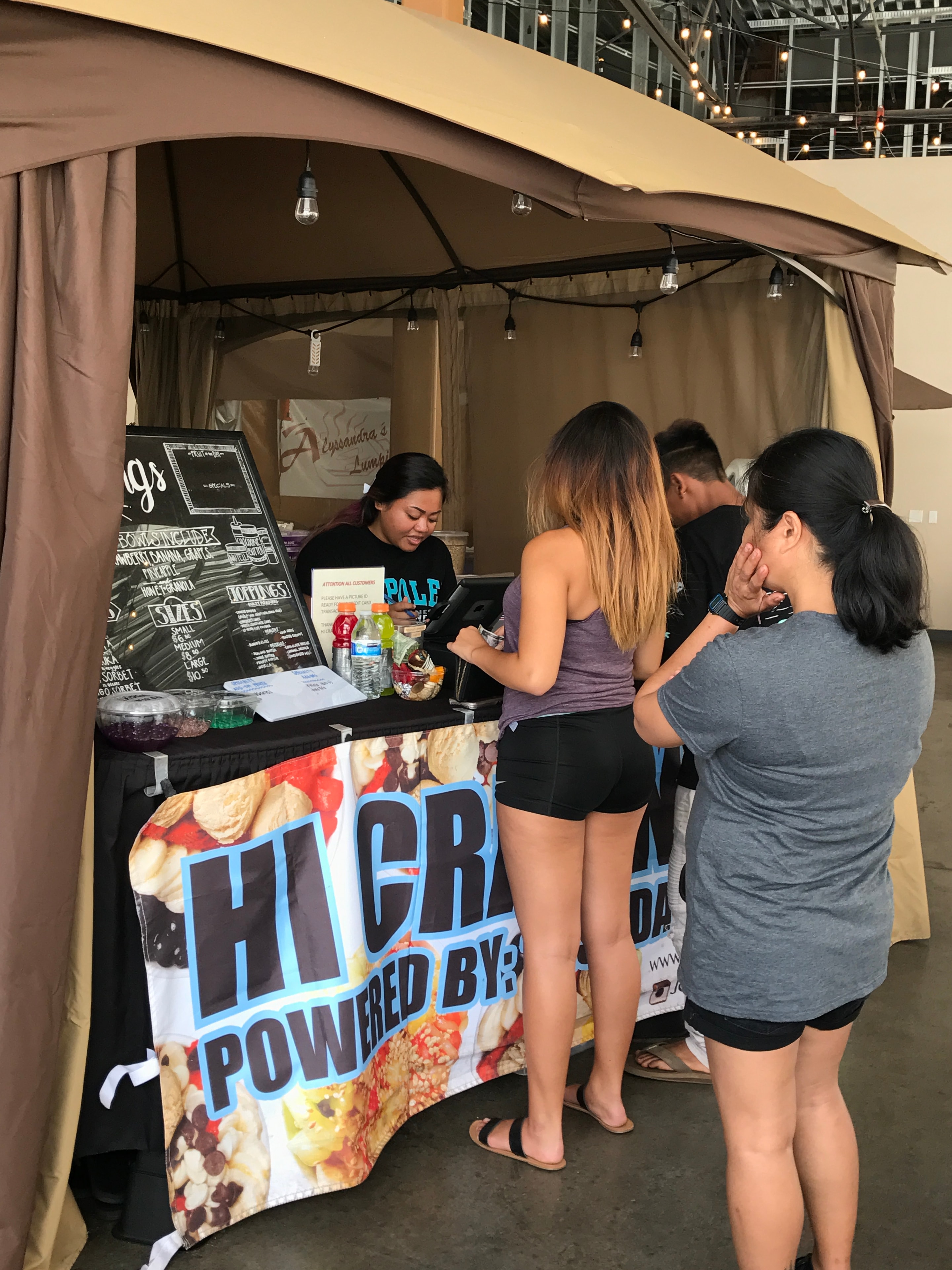 Food vendor tent customers ordering snacks